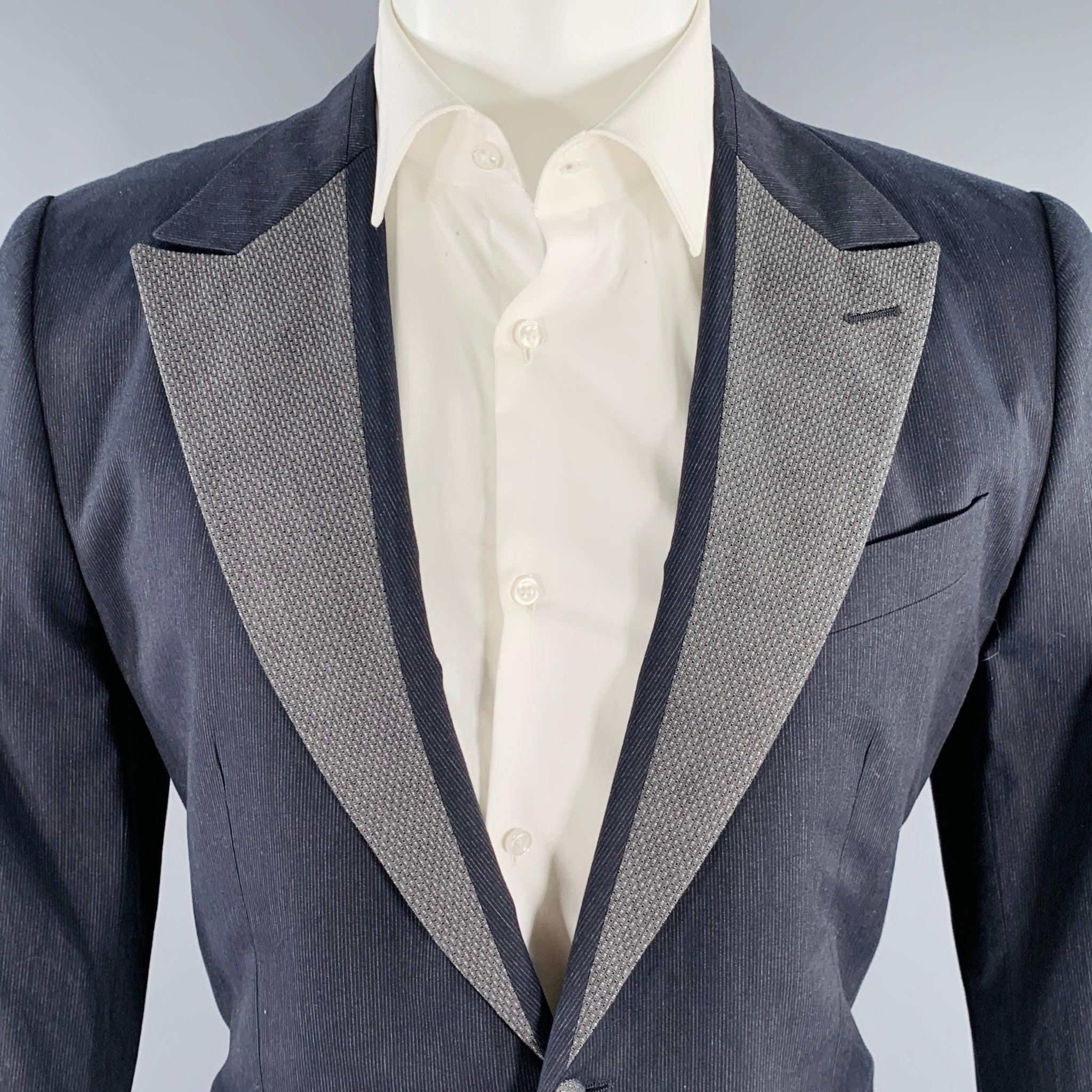 DOLCE & GABBANA long sleeve sport coat in charcoal cotton features a two button closure, straight flap pockets and a grey pinstripe notch lapel. Made in Italy. Excellent Pre-Owned Condition. 

Marked:   IT 50 

Measurements: 
 
Shoulder: 17 inches
