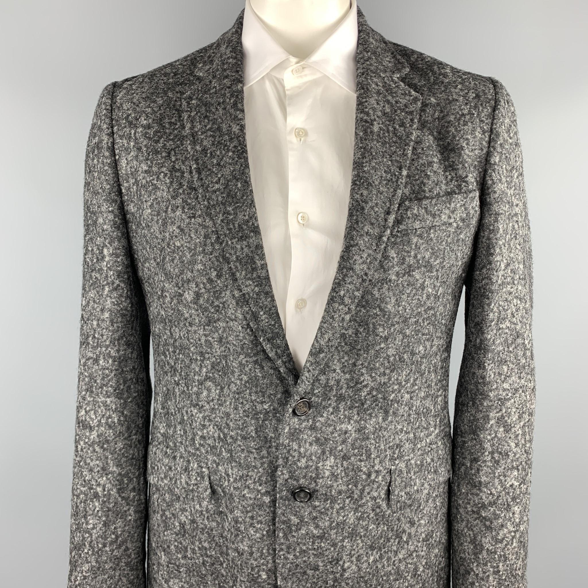 DOLCE & GABBANA sport coat comes in a gray heather alpaca / nylon featuring a notch lapel, flap pocket, and a two button closure. Made in Italy.

Excellent Pre-Owned Condition.
Marked: IT 50 

Measurements:

Shoulder: 18 in. 
Chest: 40 in. 
Sleeve: