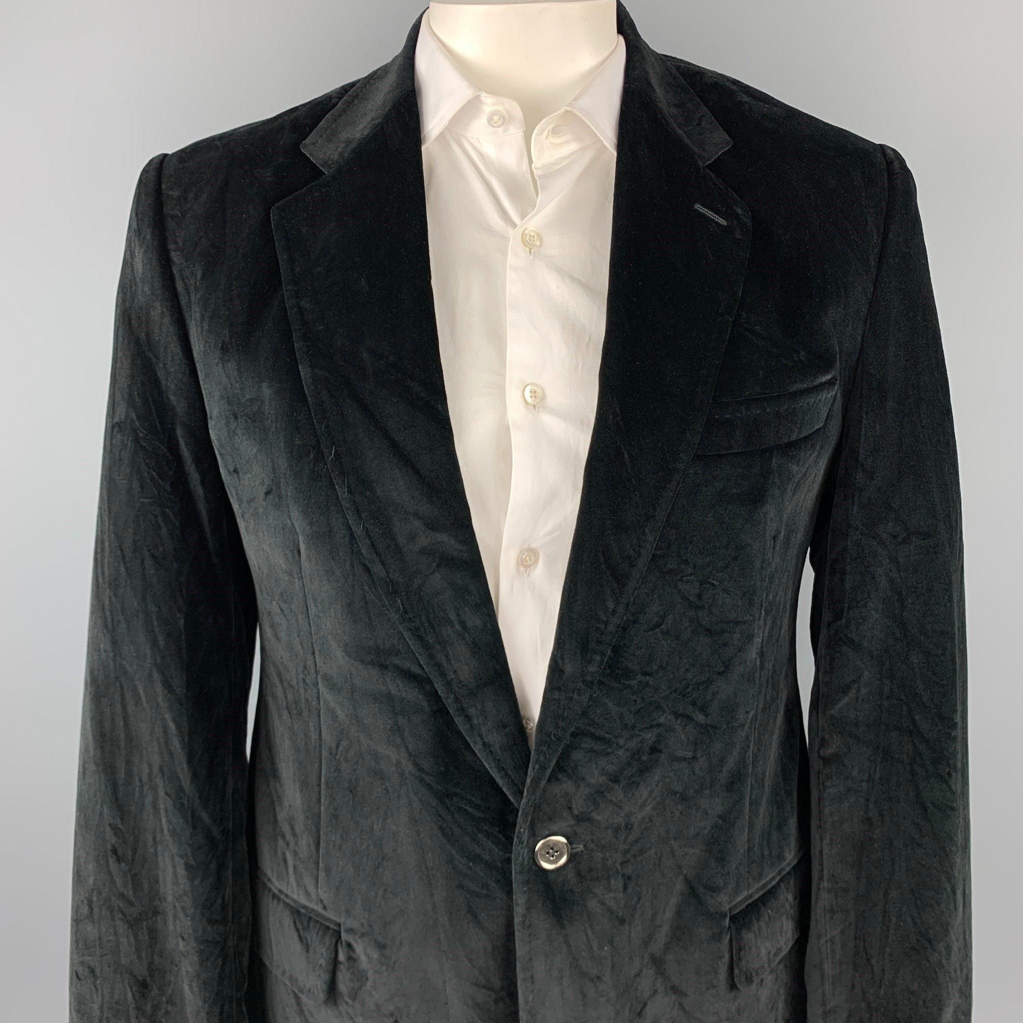 DOLCE & GABBANA sport coat comes in a black cotton velvet material with a burgundy monogram liner, featuring a notch lapel, two buttons at closure, slit and flap pockets, single breasted, buttoned cuffs, and a double vent at back. Jacket liner has