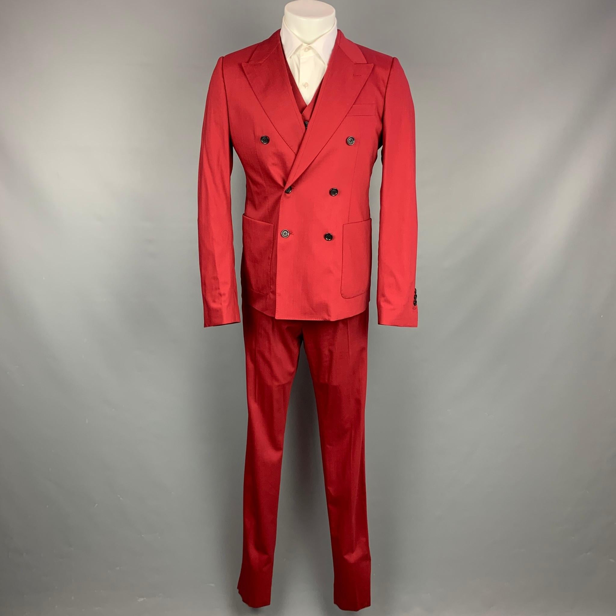 DOLCE & GABBANA suit comes in red wool / silk with a full liner and includes a double breasted sport coat with peak lapel and matching vest and flat front trousers. Made in Italy.

New With Tags.
Marked: Jacket: IT 50
Vest: IT 50
Pants: IT