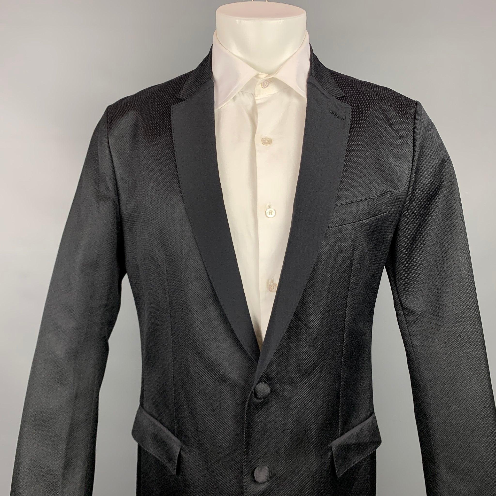 DOLCE & GABBANA sport coat comes in a black silk blend with no liner featuring a notch lapel, flap pockets, and a double button closure. Made in Italy.Very Good
Pre-Owned Condition. 

Marked:   IT 52 

Measurements: 
 
Shoulder: 18 inches  Chest: 42