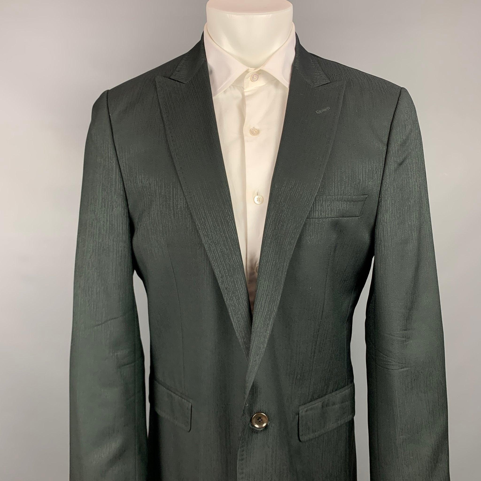 DOLCE & GABBANA sport coat comes in a black wool / viscose with a full liner featuring a peak lapel, flap pockets, and a single button closure. Made in Italy.Very Good
Pre-Owned Condition. 

Marked:   IT 52 

Measurements: 
 
Shoulder: 18 inches 
