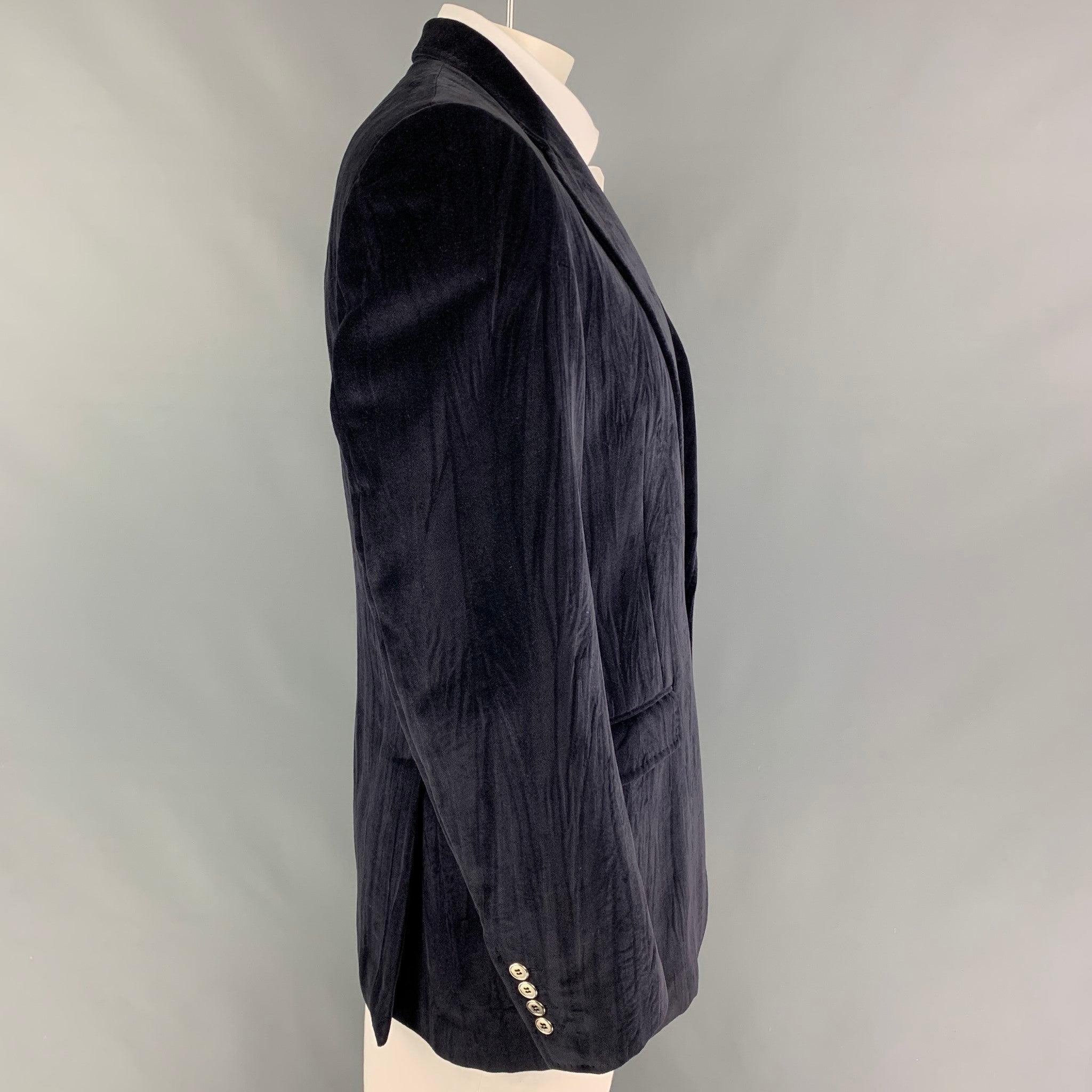 DOLCE & GABBANA sport coat comes in a dark purple cotton witch a full liner featuring a notch lapel, flap pockets, double back vent, and a single button closure. Made in Italy.
Very Good
Pre-Owned Condition. 

Marked:   52 

Measurements: 

