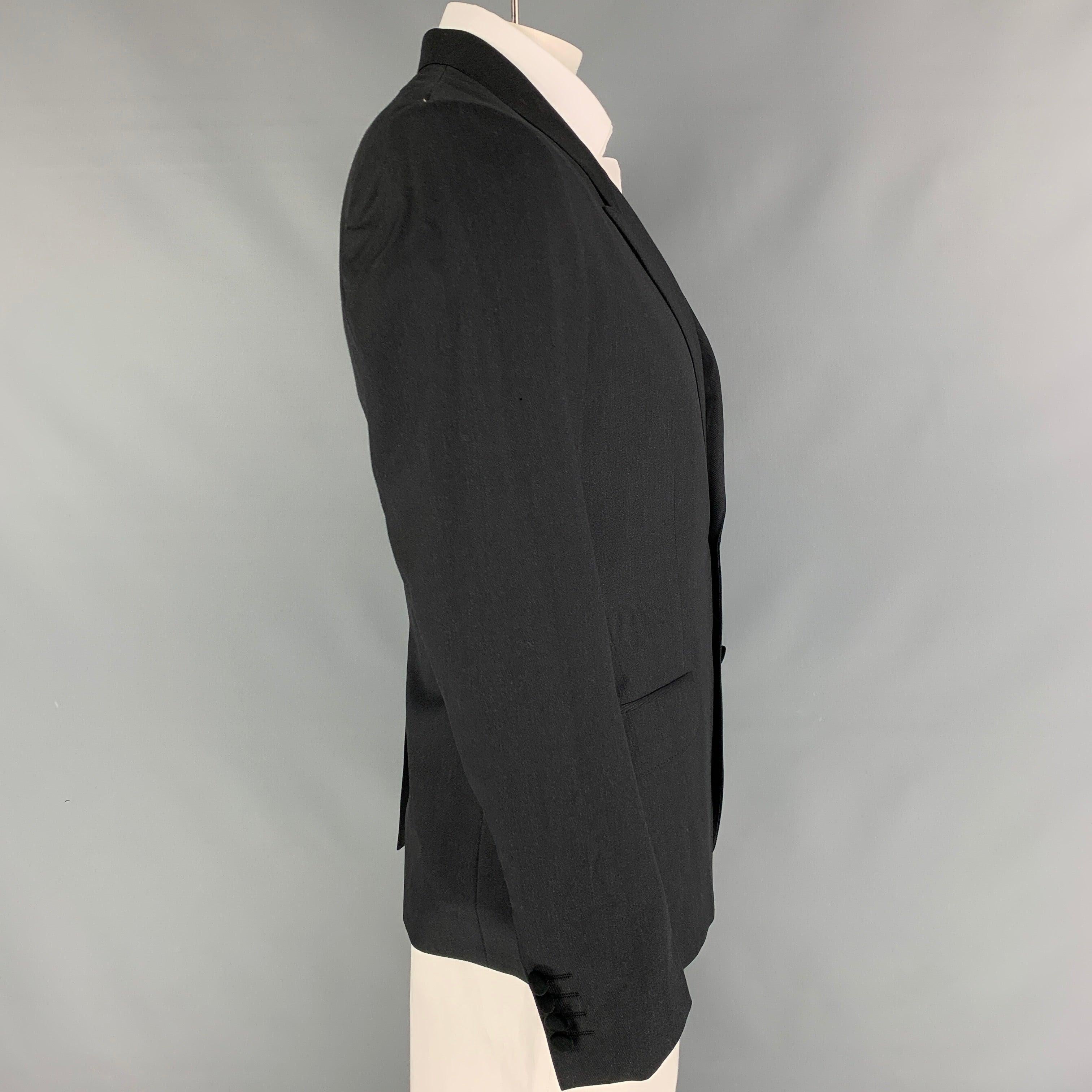 DOLCE & GABBANA sport coat in a charcoal wool with a full liner featuring a peak lapel, flap pockets, single back vent, and a double button closure. Made in Italy.
Very Good
Pre-Owned Condition. 

Marked:   IT 52 

Measurements: 
 
Shoulder: 18