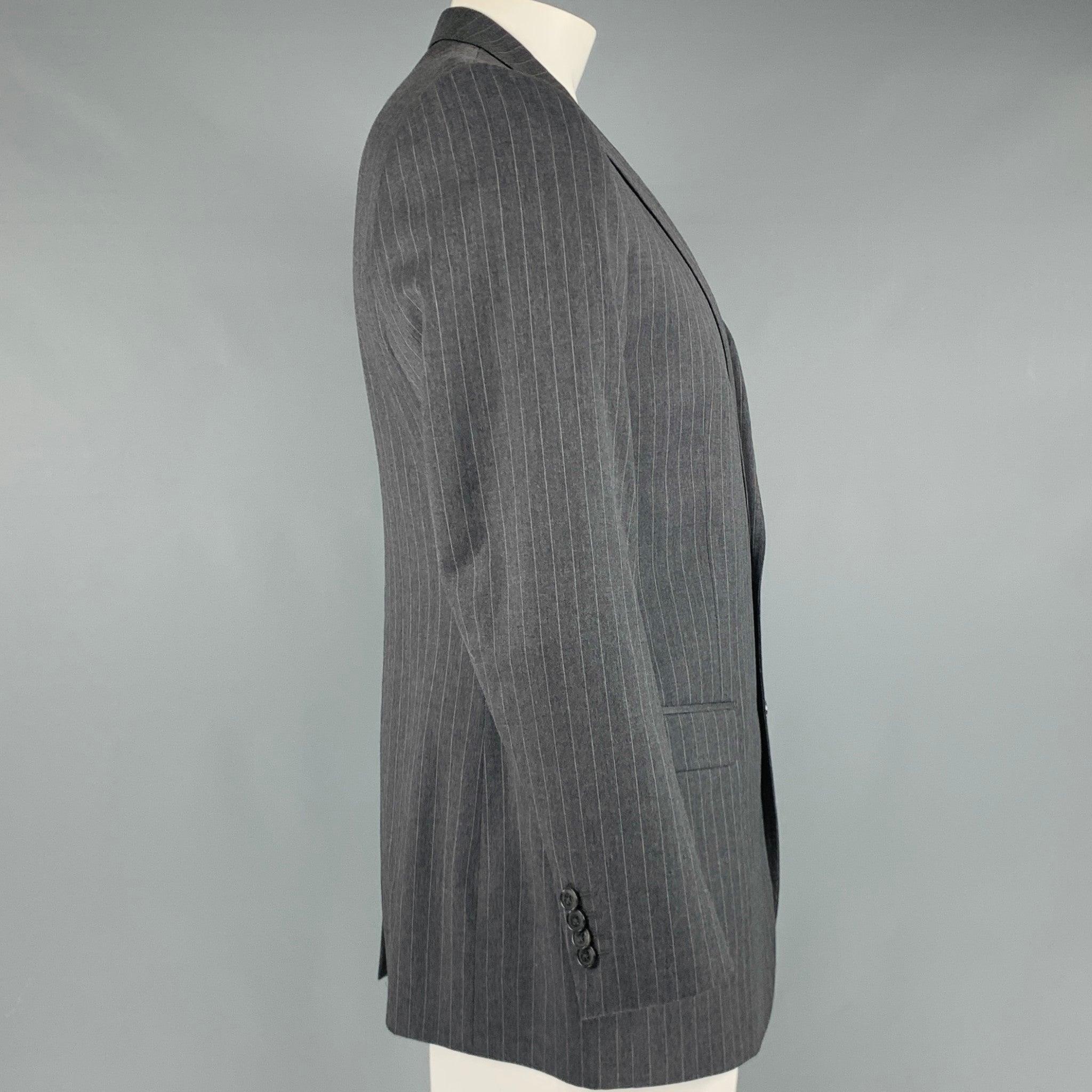 DOLCE & GABBANA sport coat
in a grey and white virgin wool fabric featuring a pinstripe pattern, notch lapel, and double button closure. Made in Italy.Excellent Pre-Owned Condition. 

Marked:   52 

Measurements: 
 
Shoulder: 18 inches Chest: 42
