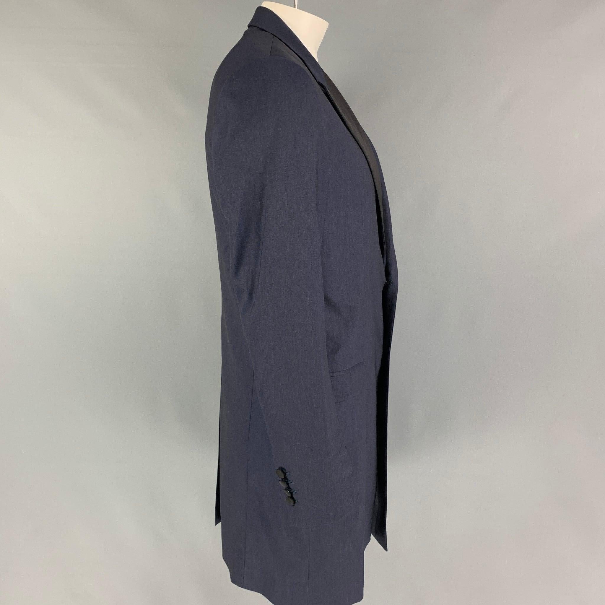 DOLCE & GABBANA coat comes in a navy & black wool with a full liner featuring a peak lapel, flap pockets, single back vent, and a double button closure. Made in Italy.Very Good
Pre-Owned Condition. 

Marked:  52 

Measurements: 
 
Shoulder: 18