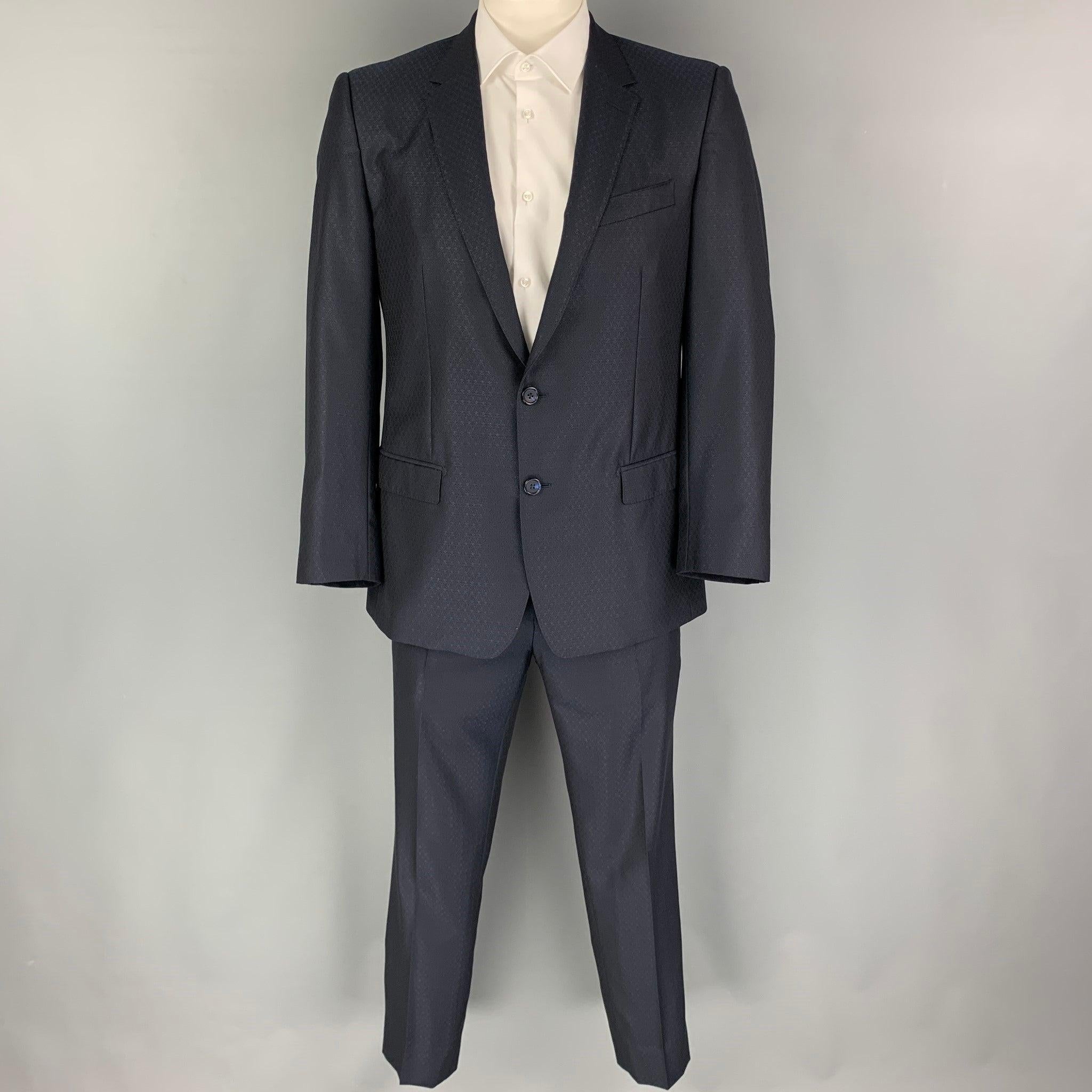 DOLCE & GABBANA suit comes in a navy print wool blend with a full liner and includes a single breasted, double button sport coat with a notch lapel and matching flat front trousers. Excellent Pre-Owned Condition. 

Marked:   52 

Measurements: 
 