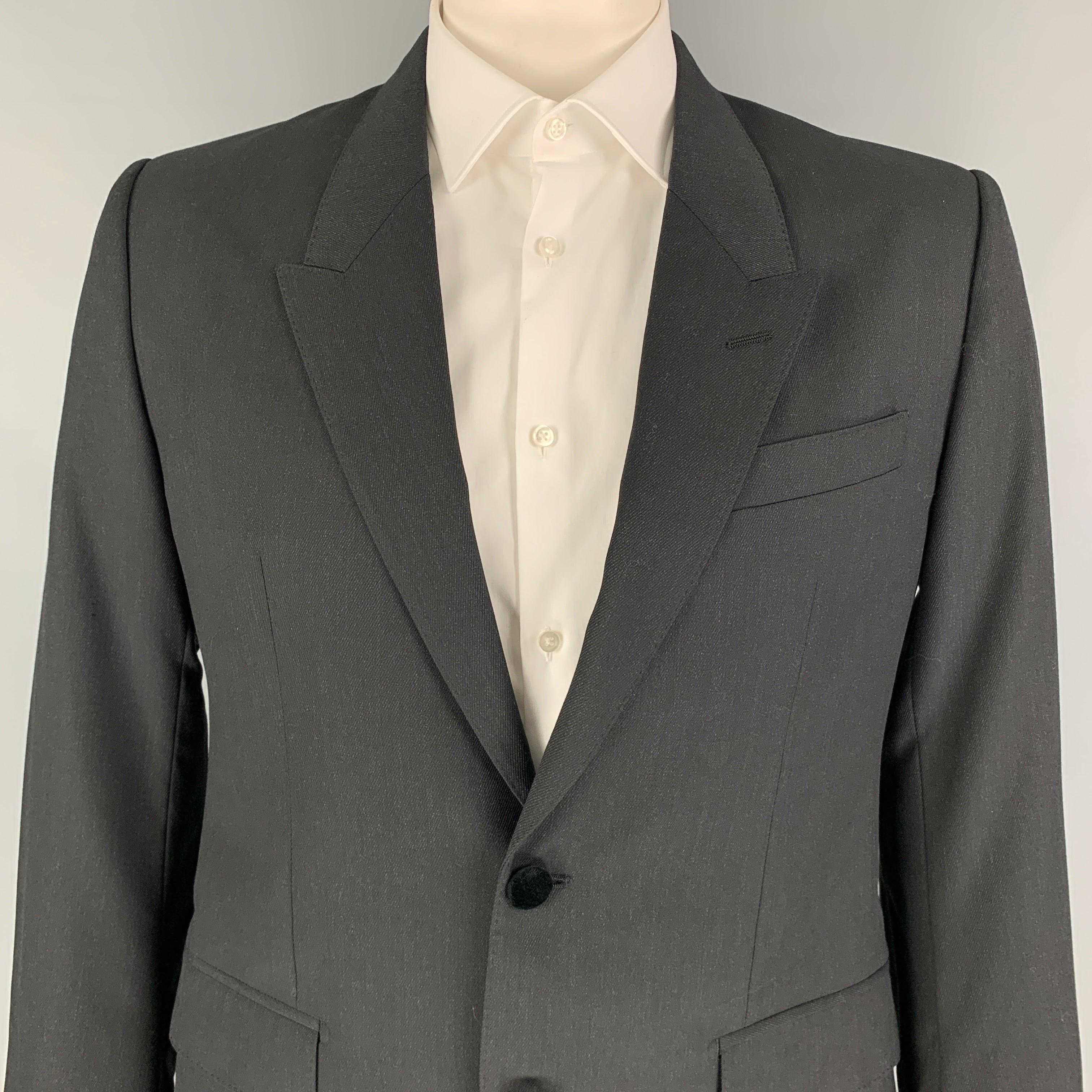 DOLCE & GABBANA sport coat comes in a charcoal wool with a full liner featuring a peak lapel, flap pockets, single back vent, and a double button closure. Made in Italy.
Very Good
Pre-Owned Condition. 

Marked:   52 

Measurements: 
 
Shoulder: 18