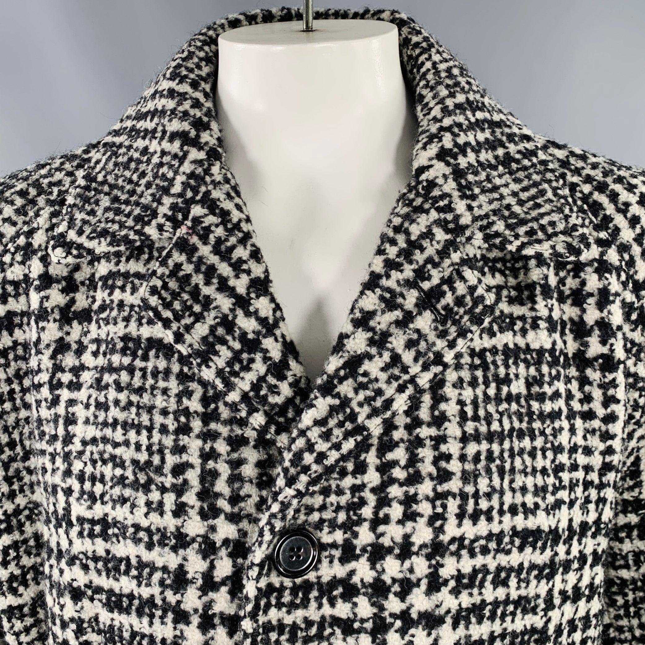 DOLCE & GABBANA coat
in a black and white wool blend fabric featuring an oversized style, plaid pattern, and button closure with belt. Made in Italy.Excellent Pre-Owned Condition. 

Marked:   IT 54 

Measurements: 
 
Shoulder: 19 inches Chest: 48