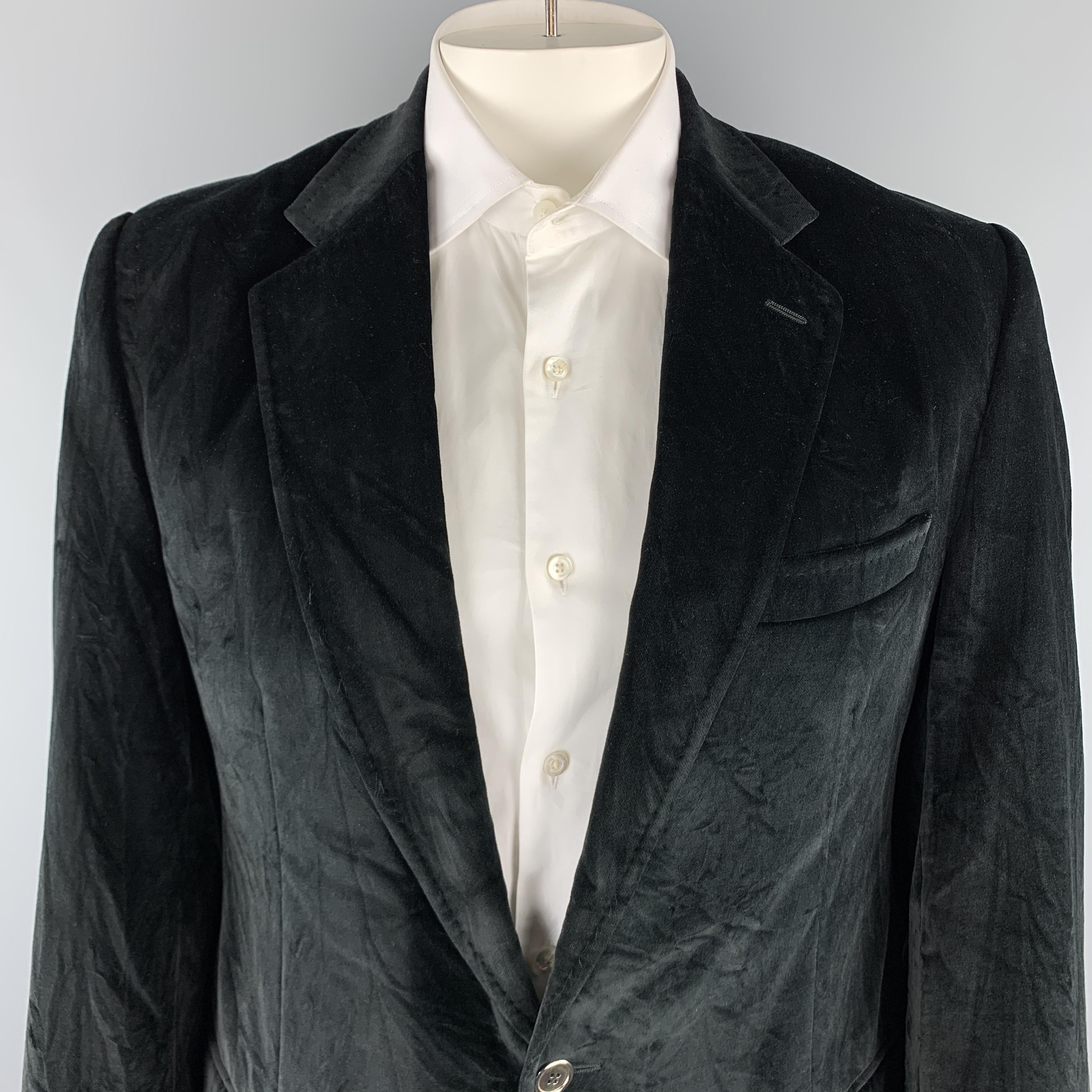 DOLCE & GABBANA sport coat comes in a black cotton velvet material, featuring a notch lapel, two buttons at closure, slit and flap pockets, single breasted, buttoned cuffs, and a double vent at back. Wear throughout from storage. Made in