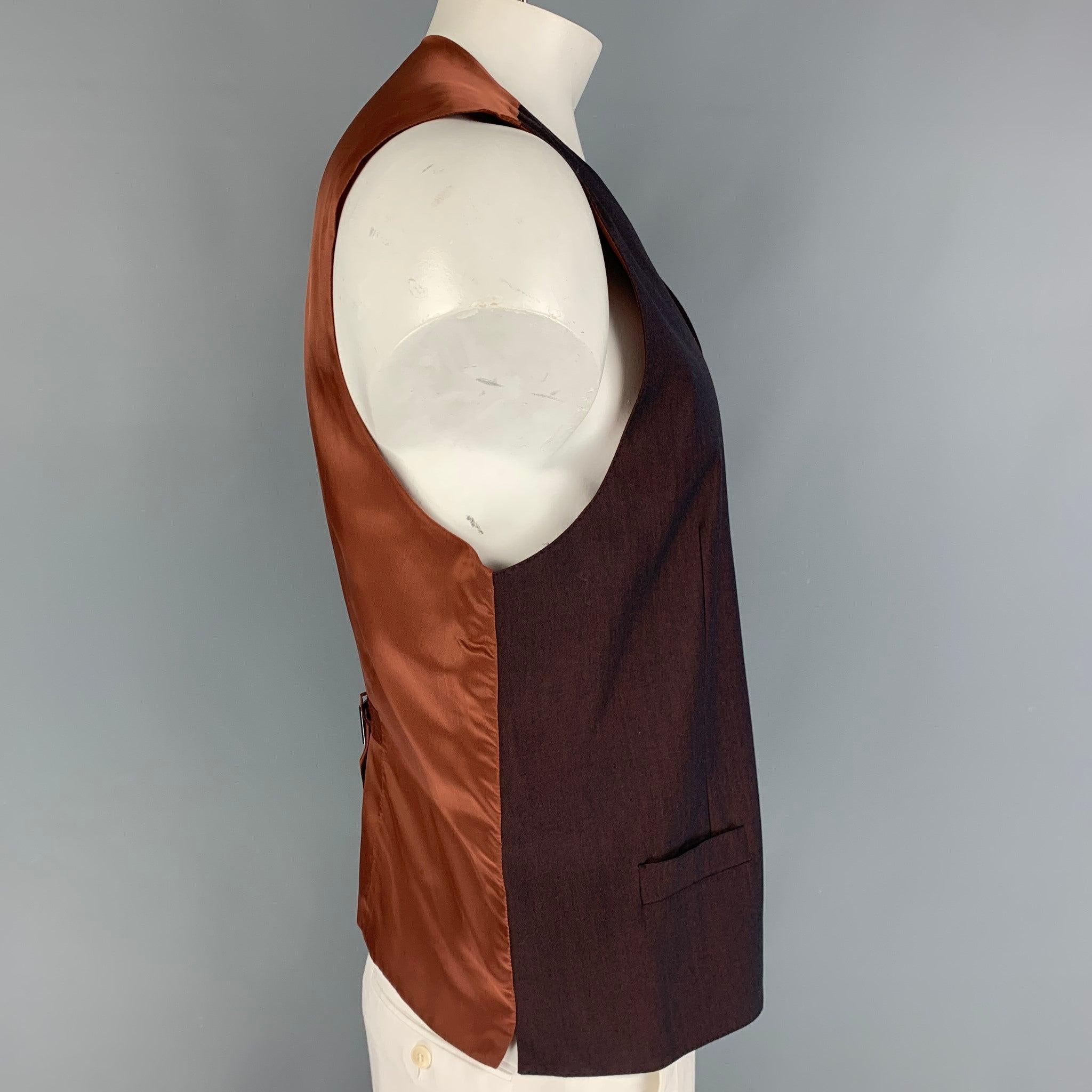 DOLCE & GABBANA dress vest comes in a brown wool fabric, full lined featuring V-neck, welt pockets, five buttons down closure, brown viscose fabric back and adjustable sliding belt. Made in Italy.Excellent Pre-Owned Condition.  

Marked:   no size