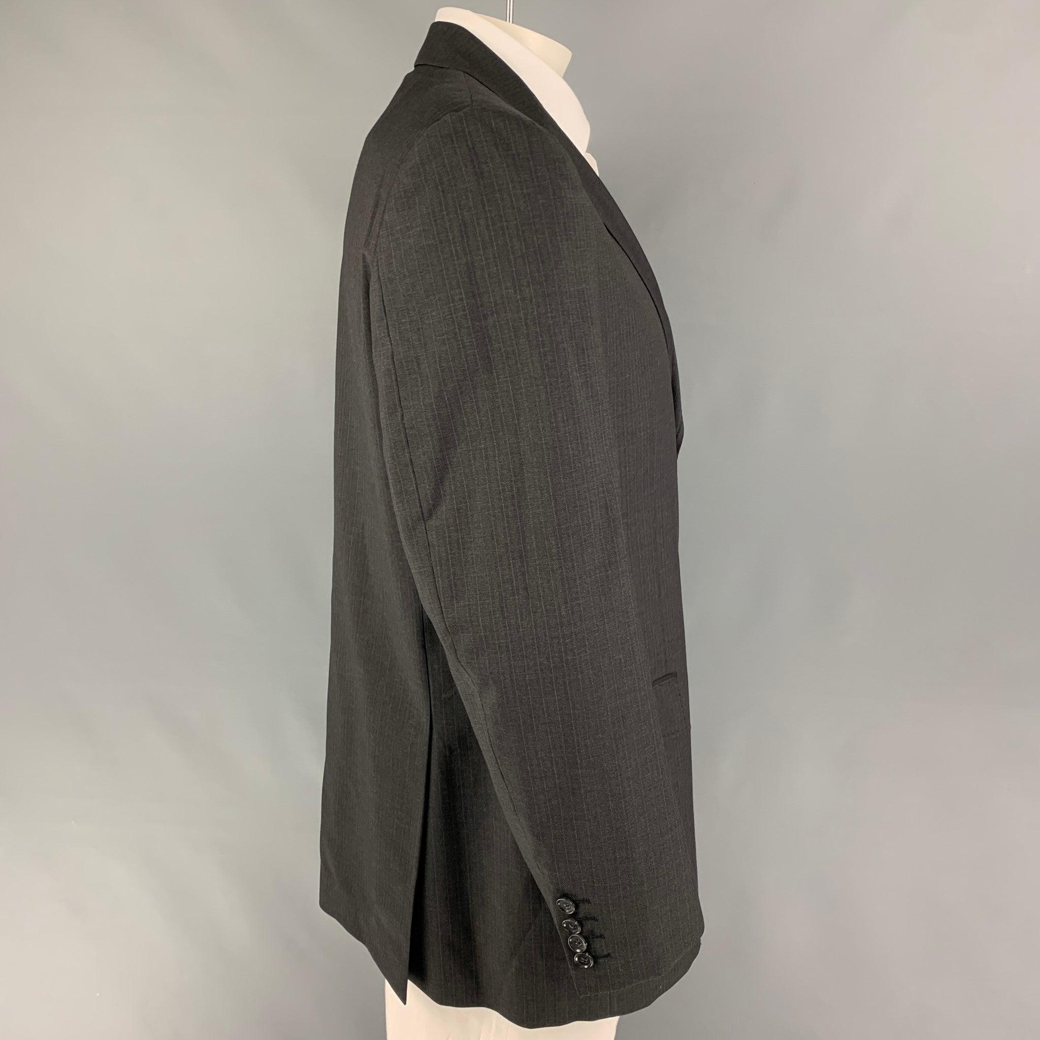 DOLCE & GABBANA sport coat comes in a charcoal pinstripe virgin wool with a full liner featuring a notch lapel, flap pockets, single back vent, and a three button closure. Made in Italy. Very Good Pre-Owned Condition. 

Marked:   Size not visible