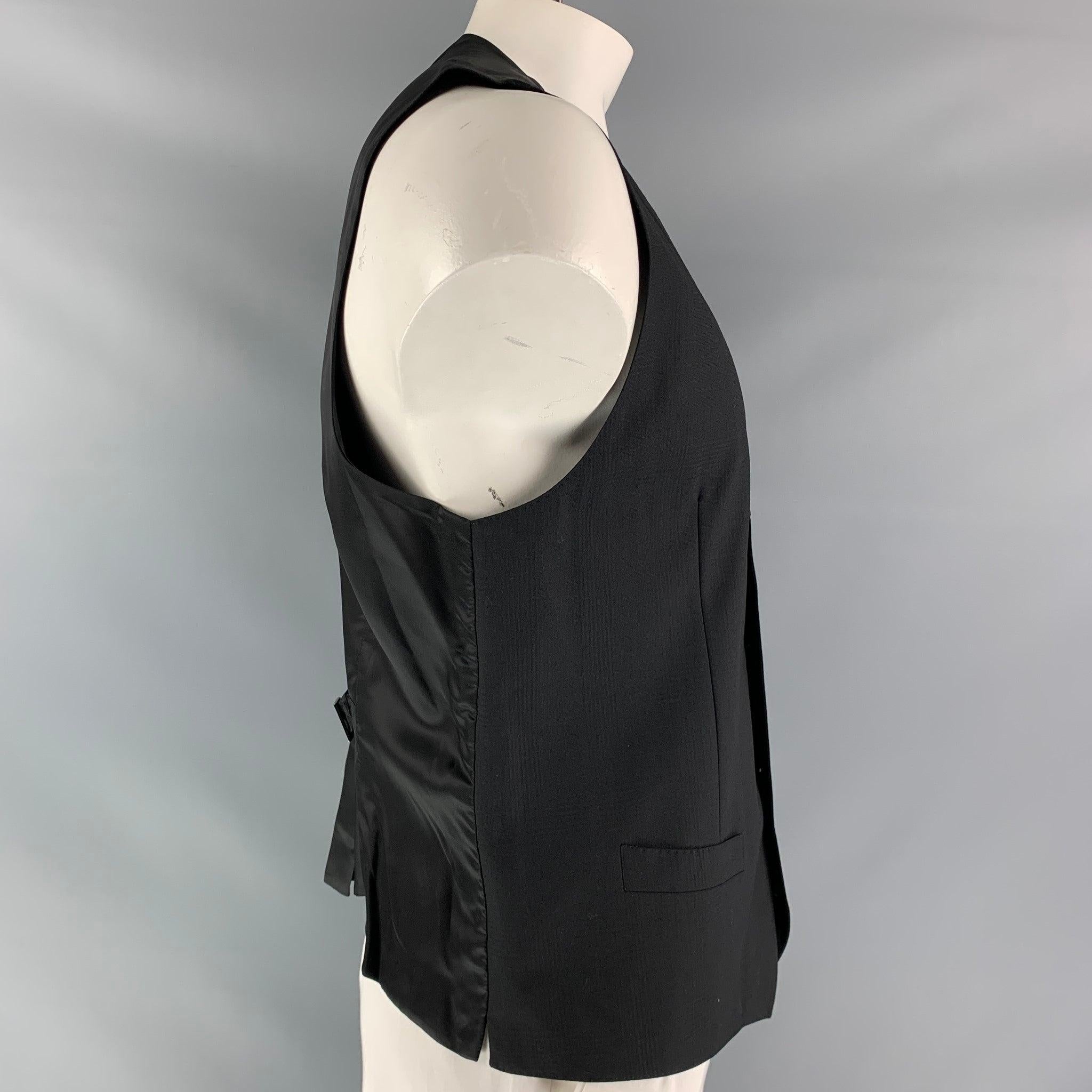 DOLCE & GABBANA dress vest comes in a black plaid wool fabric, full lined featuring V-neck, welt pockets, five buttons down closure, black viscose fabric back and adjustable sliding belt. Made in Italy.Excellent Pre-Owned Condition.  

Marked:   no