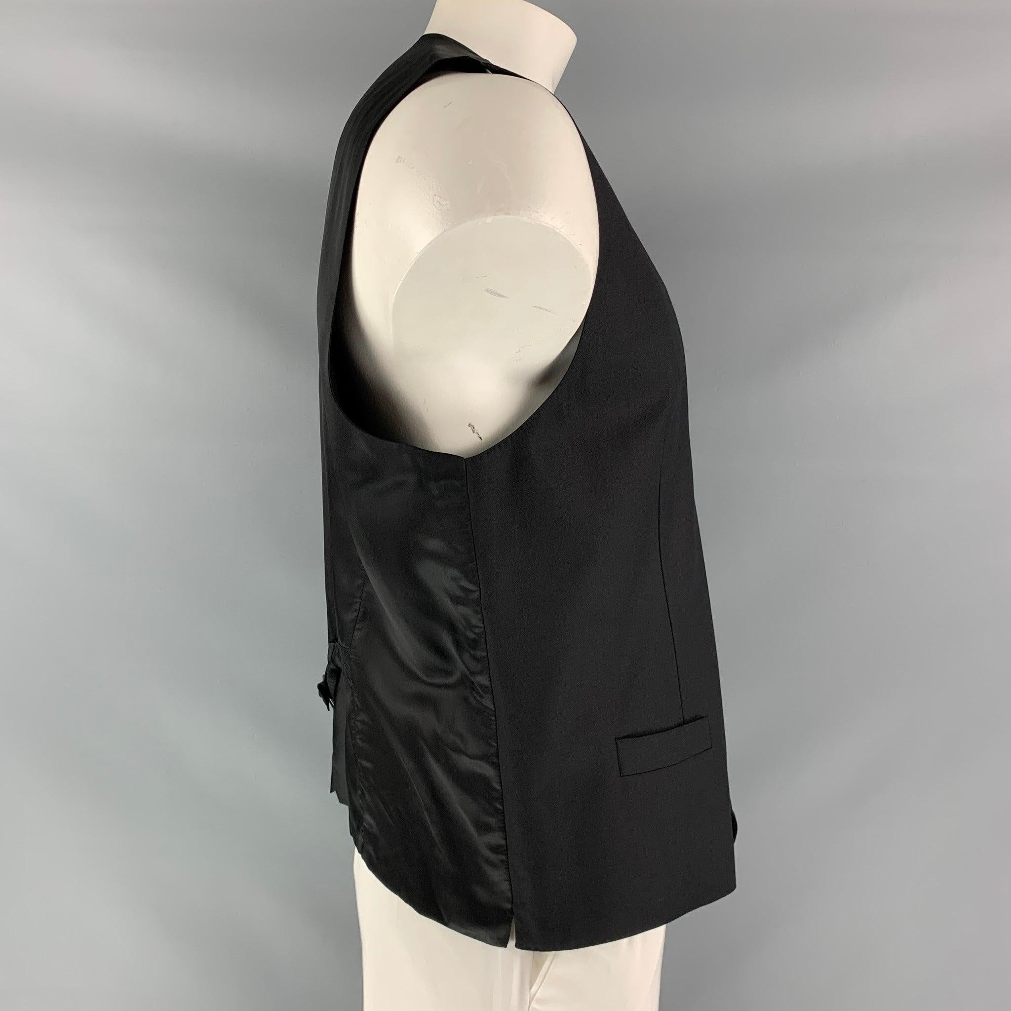 DOLCE & GABBANA dress vest comes in a black wool fabric, full lined featuring V-neck, welt pockets, five buttons down closure, black viscose fabric back and adjustable belt. Made in Italy.Excellent Pre-Owned Condition.  

Marked:   no size marked