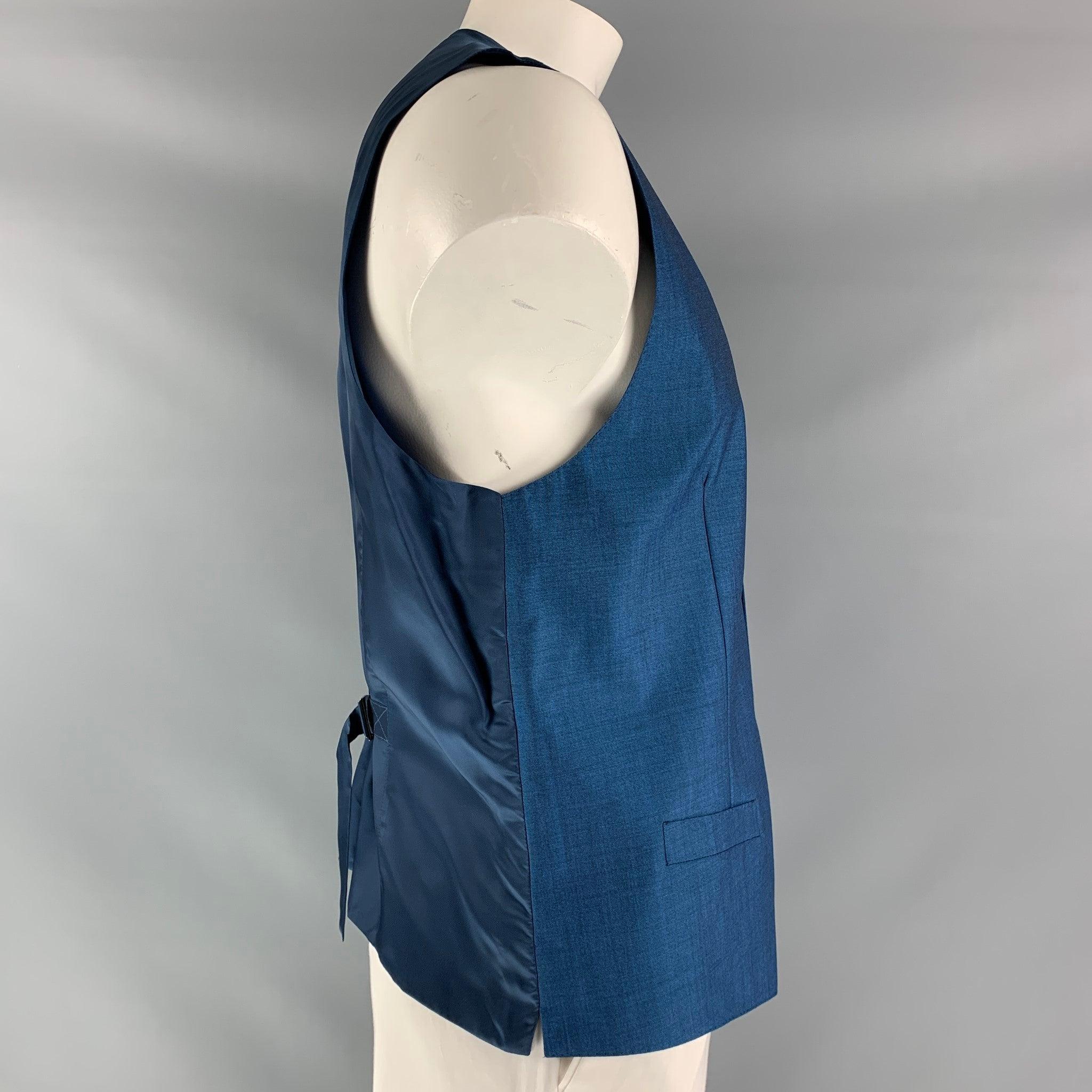 DOLCE & GABBANA dress vest comes in blue mohair and wool fabric, full lined featuring V-neck, welt pockets, five buttons down closure, blue viscose fabric at back and adjustable sliding belt. Made in Italy.Excellent Pre-Owned Condition.  

Marked: 