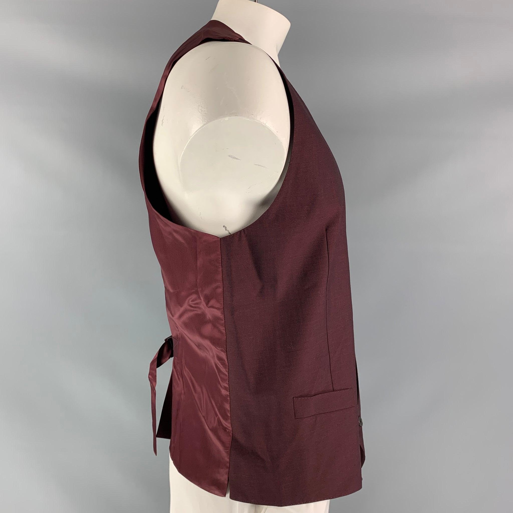 DOLCE & GABBANA dress vest comes in a burgundy mohair and wool fabric, full lined featuring V-neck, welt pockets, five buttons down closure, burgundy viscose fabric back and adjustable sliding belt. Made in Italy.Excellent Pre-Owned Condition. 