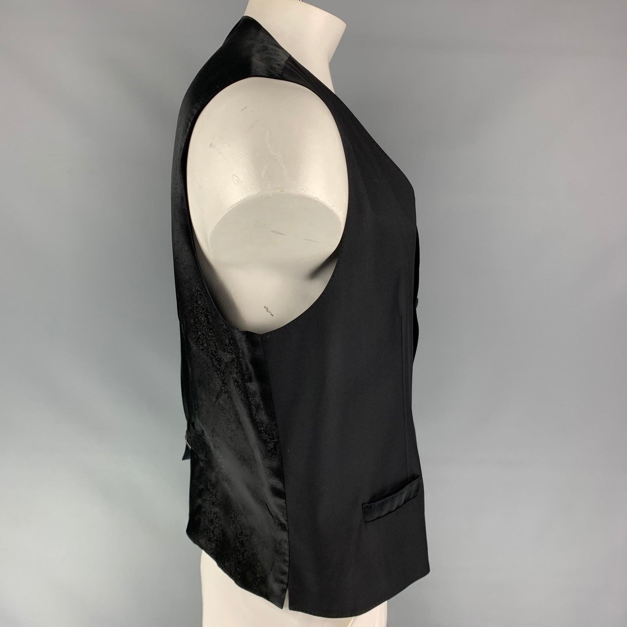 DOLCE & GABBANA vest comes in black wool blend featuring a classic style, back belt, slit pockets, and a buttoned closure. Made in Italy.Very Good
Pre-Owned Condition. 

Marked:   58 

Measurements: 
 
Shoulder: 16 inches  Chest: 44 inches  Length: