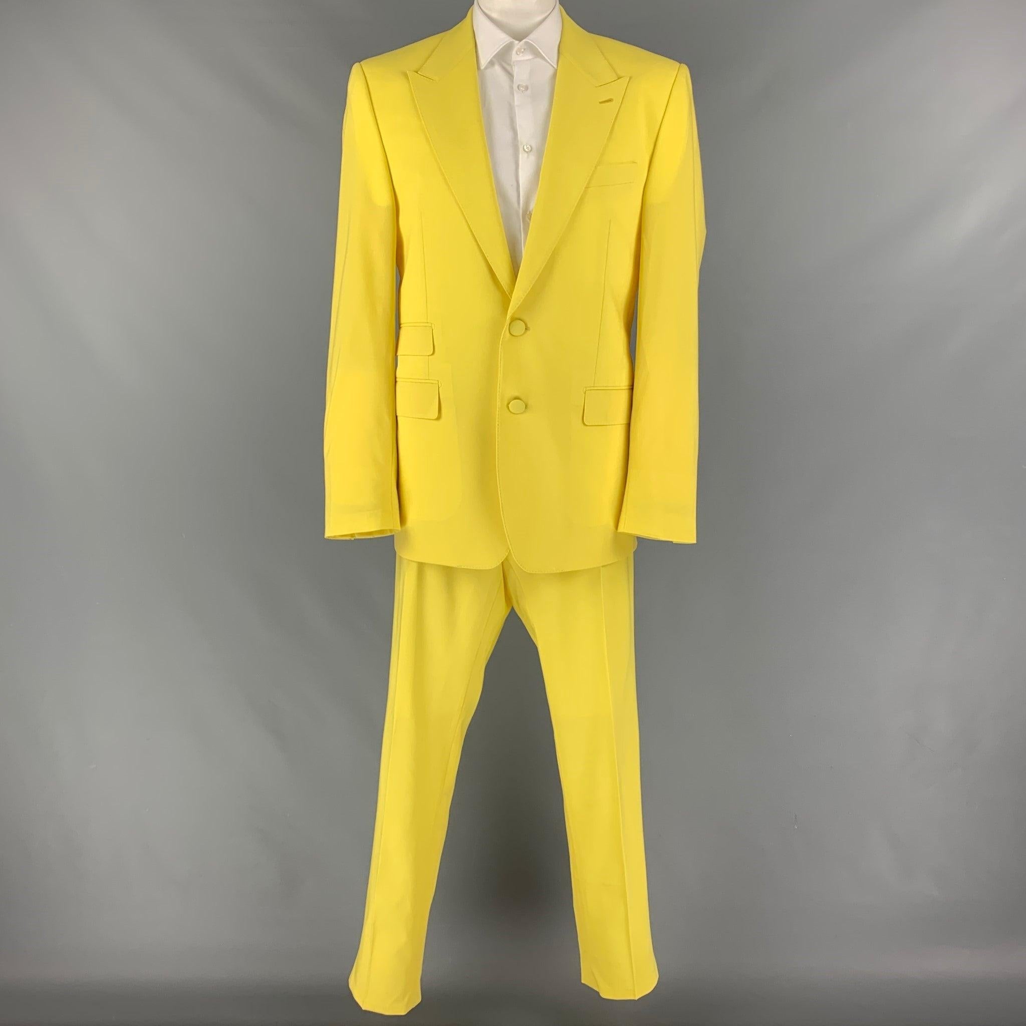 DOLCE & GABBANA
suit comes in a yellow wool with a full liner and includes a single breasted, double button sport coat with a peak lapel and matching pleated front trousers. Made in Italy. New With Tags.  

Marked:   58 

Measurements: 
 
