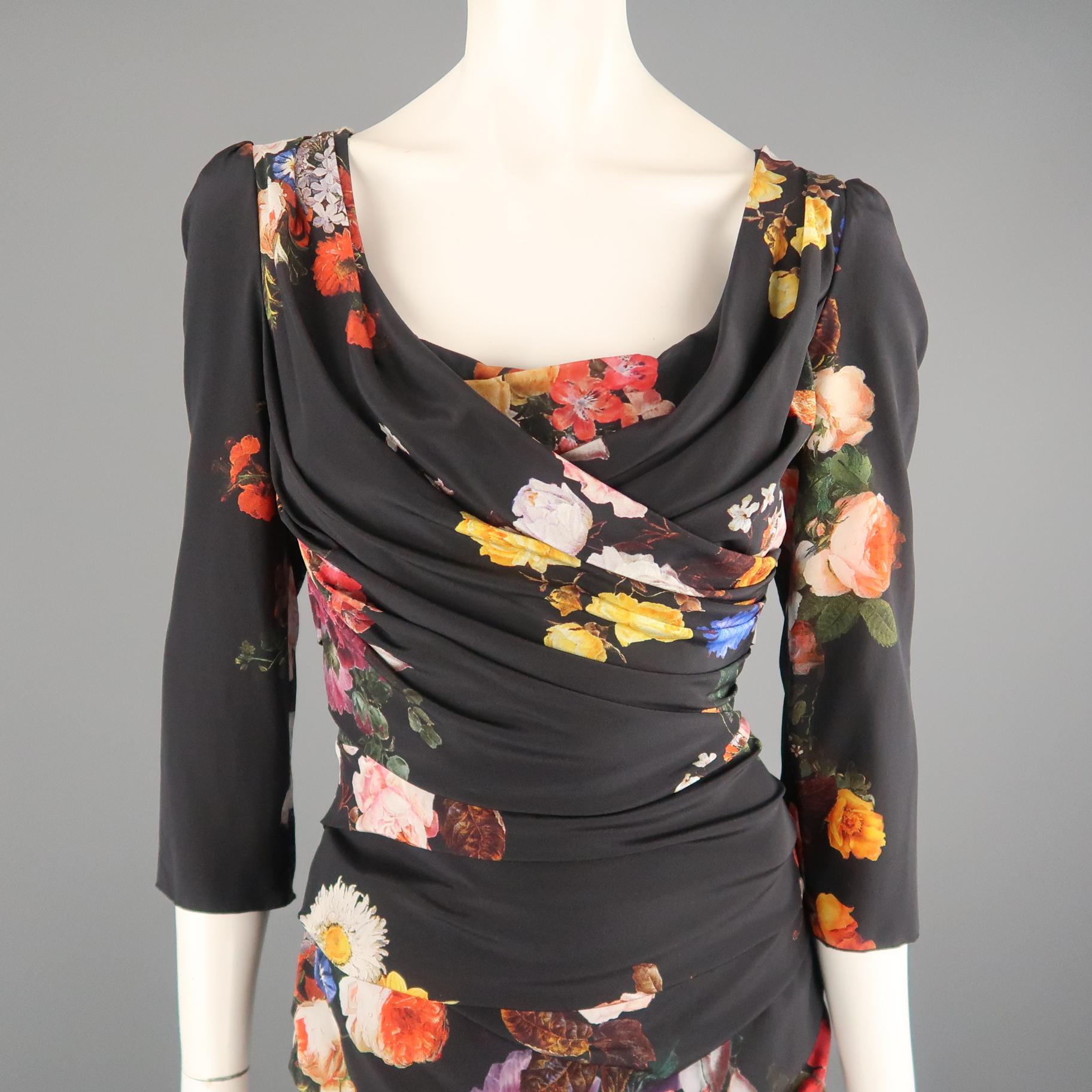 DOLCE & GABBANA sheath dress comes in black stretch silk with a multi-color floral print throughout, scoop neck, three quarter sleeves, and  drape ruching throughout.  Made in Italy.
 
New with Tags. Retails: $2,375.00.
Marked: IT 42
