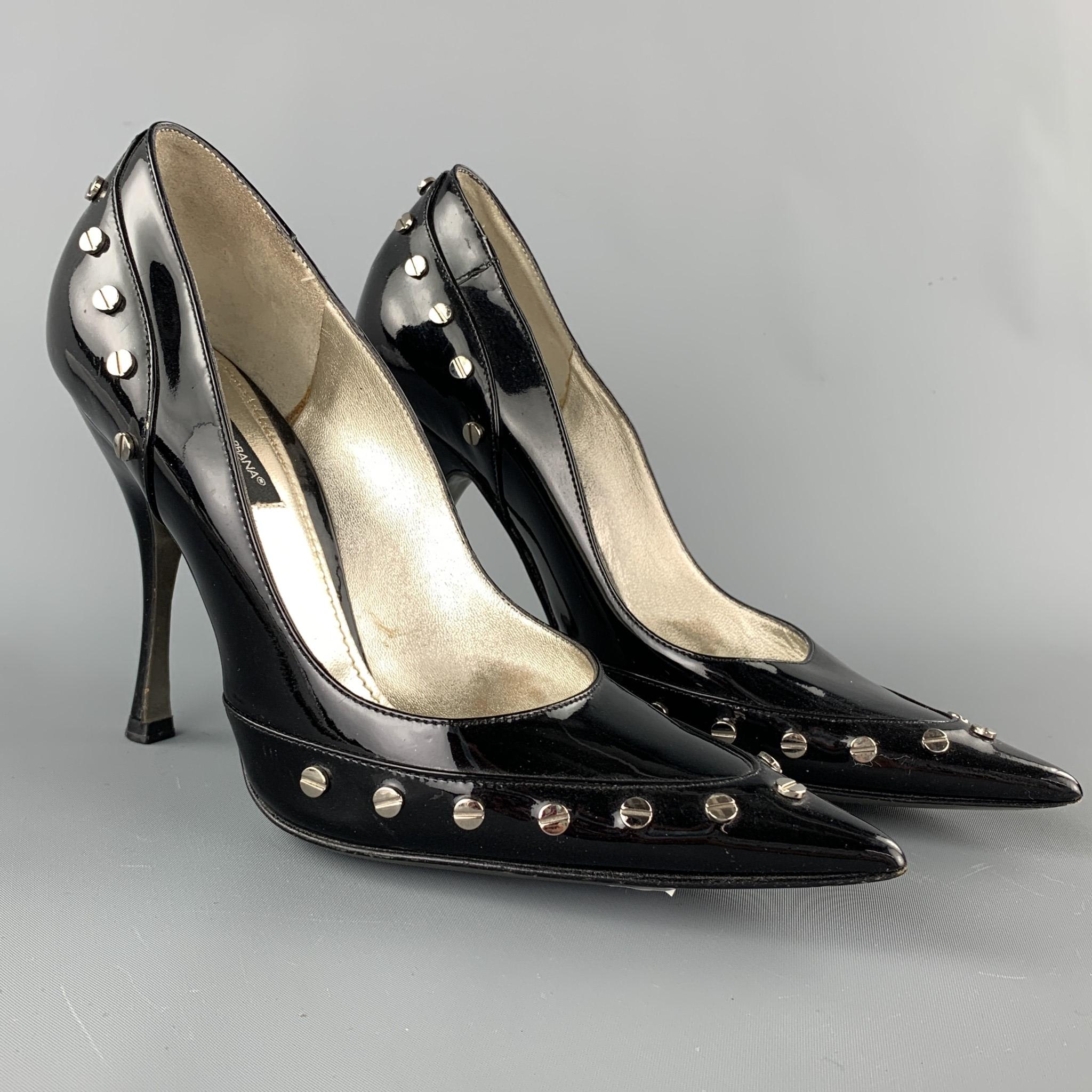 DOLCE & GABBANA pumps comes in a black patent leather with studded details featuring a pointed toe. Wear throughout. As-Is. Made in Italy.

Good Pre-Owned Condition.
Marked: IT 36

Heel: 4 in.