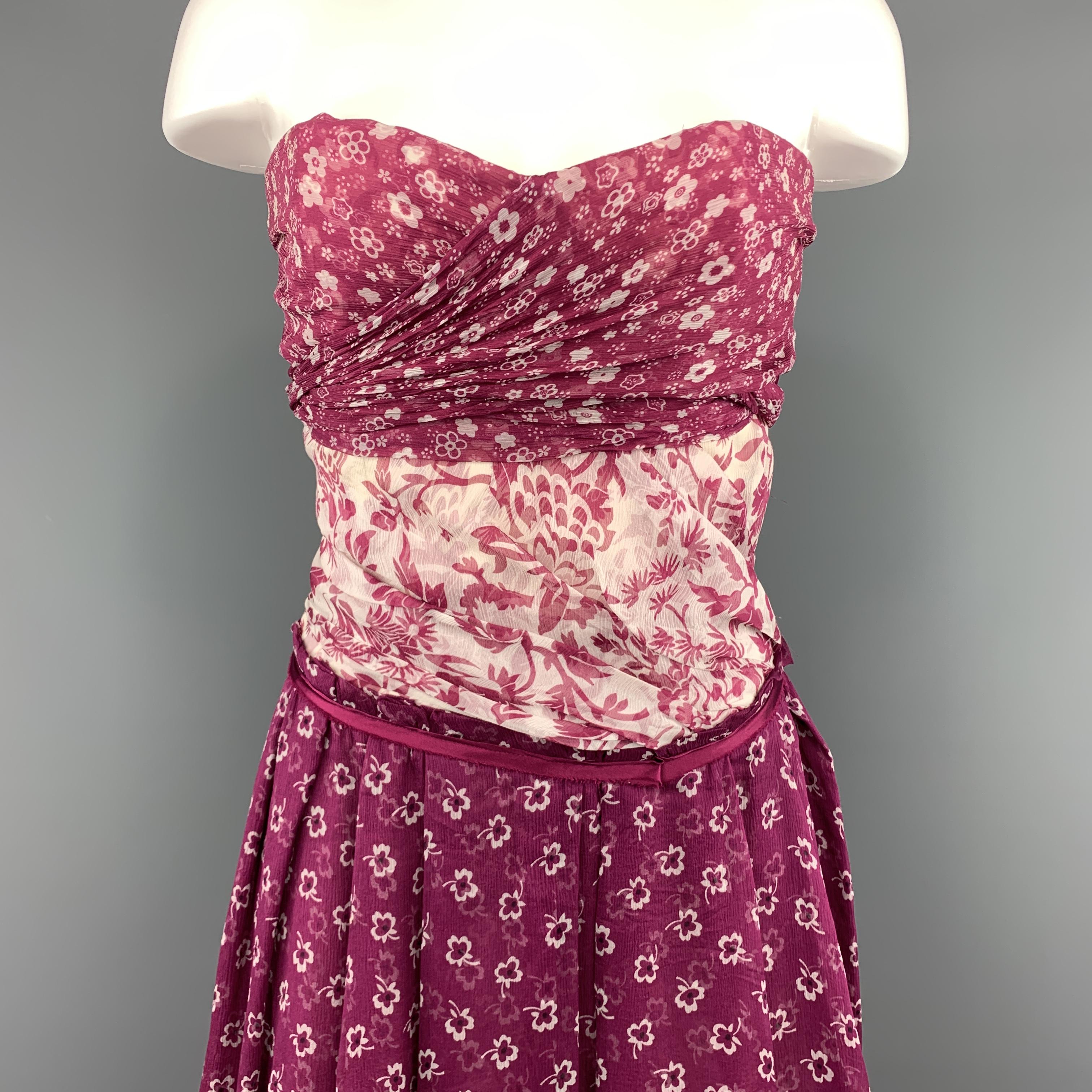 D&G by DOLCE & GABBANA strapless bustier cocktail dress comes in textured silk chiffon and features a purple draped overlay bust that ties in back, cream floral draped mid section, and ruffled pleat skirt. Made in Italy.
 
Very Good Pre-Owned