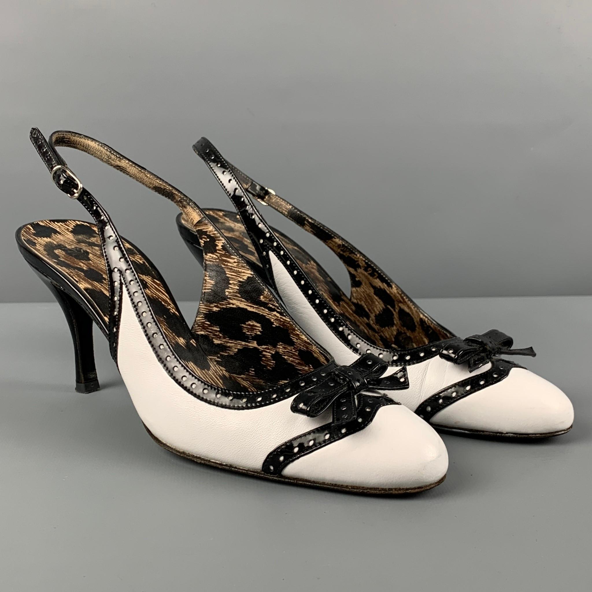 DOLCE & GABBANA pumps comes in a white & black leather with a animal print interior featuring a front bow detail, slingback closure, and a stiletto heel. Made in Italy. 

Very Good Pre-Owned Condition.
Marked: 37

Measurements:

Heel: 3 in. 
