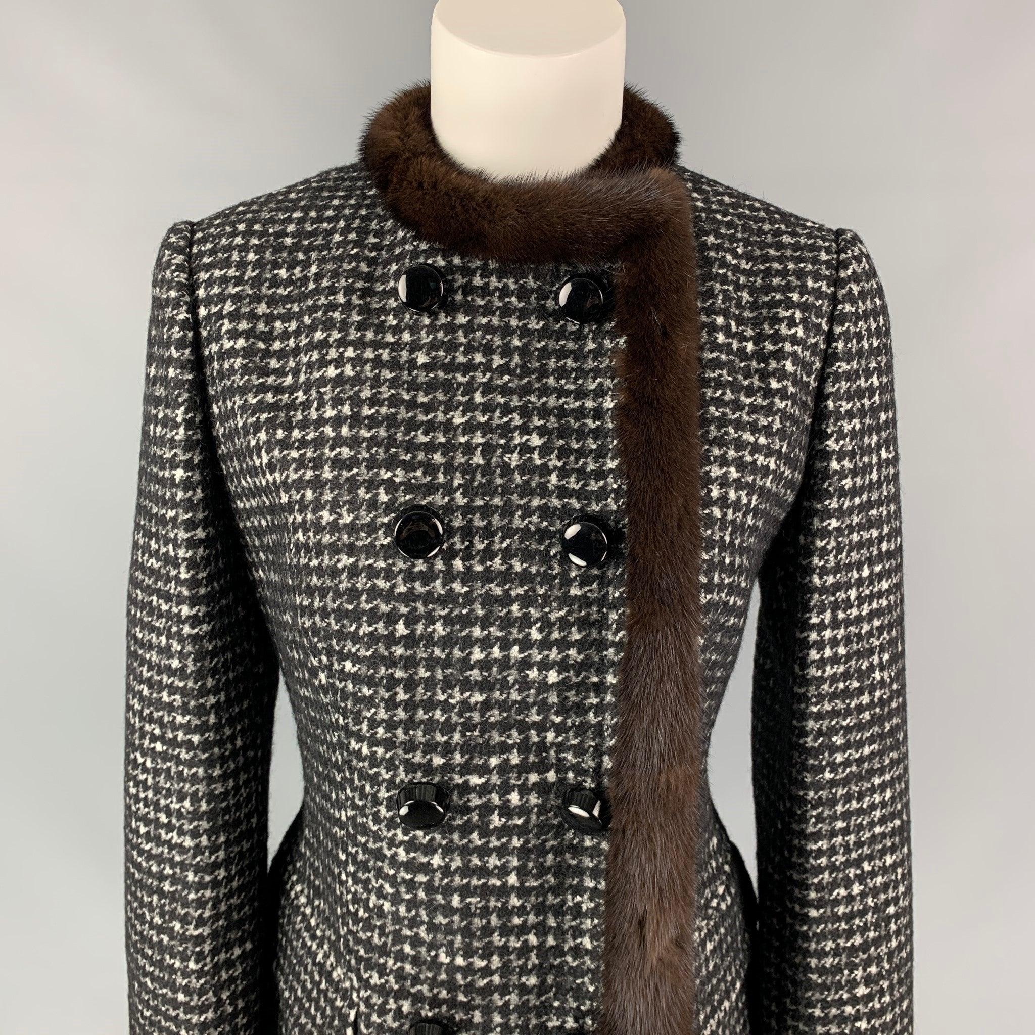 DOLCE & GABBANA jacket comes in a black & white houndstooth virgin wool with a full liner featuring a fur trim, flap pockets, and a double breasted closure. Made in Italy.Very Good
 Pre-Owned Condition. 
 

 Marked:  44 
 

 Measurements: 
  
