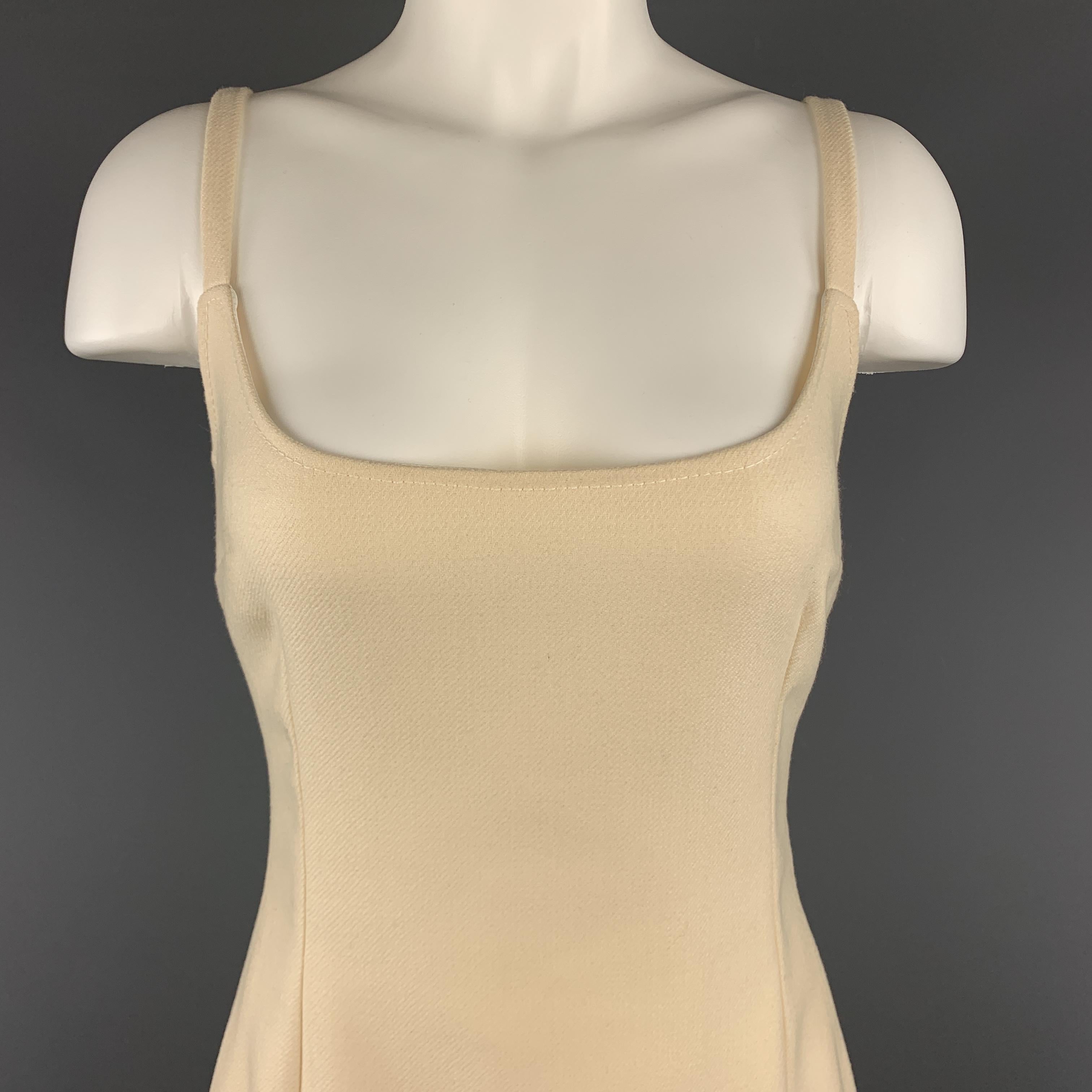 DOLCE & GABBANA classic slip sheath cut style dress comes in creamy beige virgin wool with spaghetti straps and satin liner. Made in Italy.

Excellent Pre-Owned Condition.
Marked: IT 44

Measurements:

Bust: 36 in.
Waist: 28 in.
Hip: 38 in.
Length: