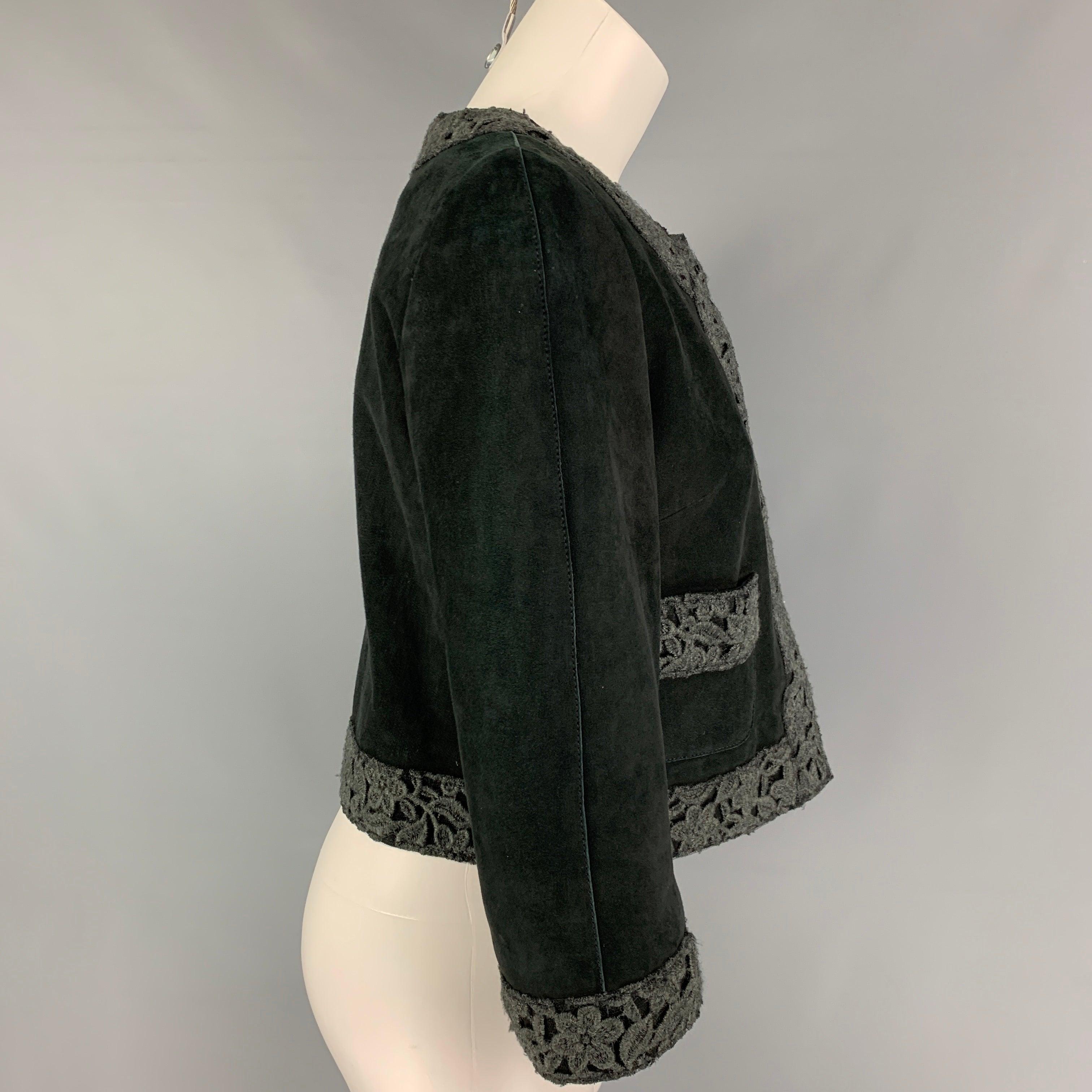 DOLCE & GABBANA jacket comes in a dak green suede featuring a floral embroidered trim, collarless, front pockets, and a snap button closure. Made in Italy.
Very Good
Pre-Owned Condition. 

Marked:   44 

Measurements: 
 
Shoulder: 14.5 inches  Bust: