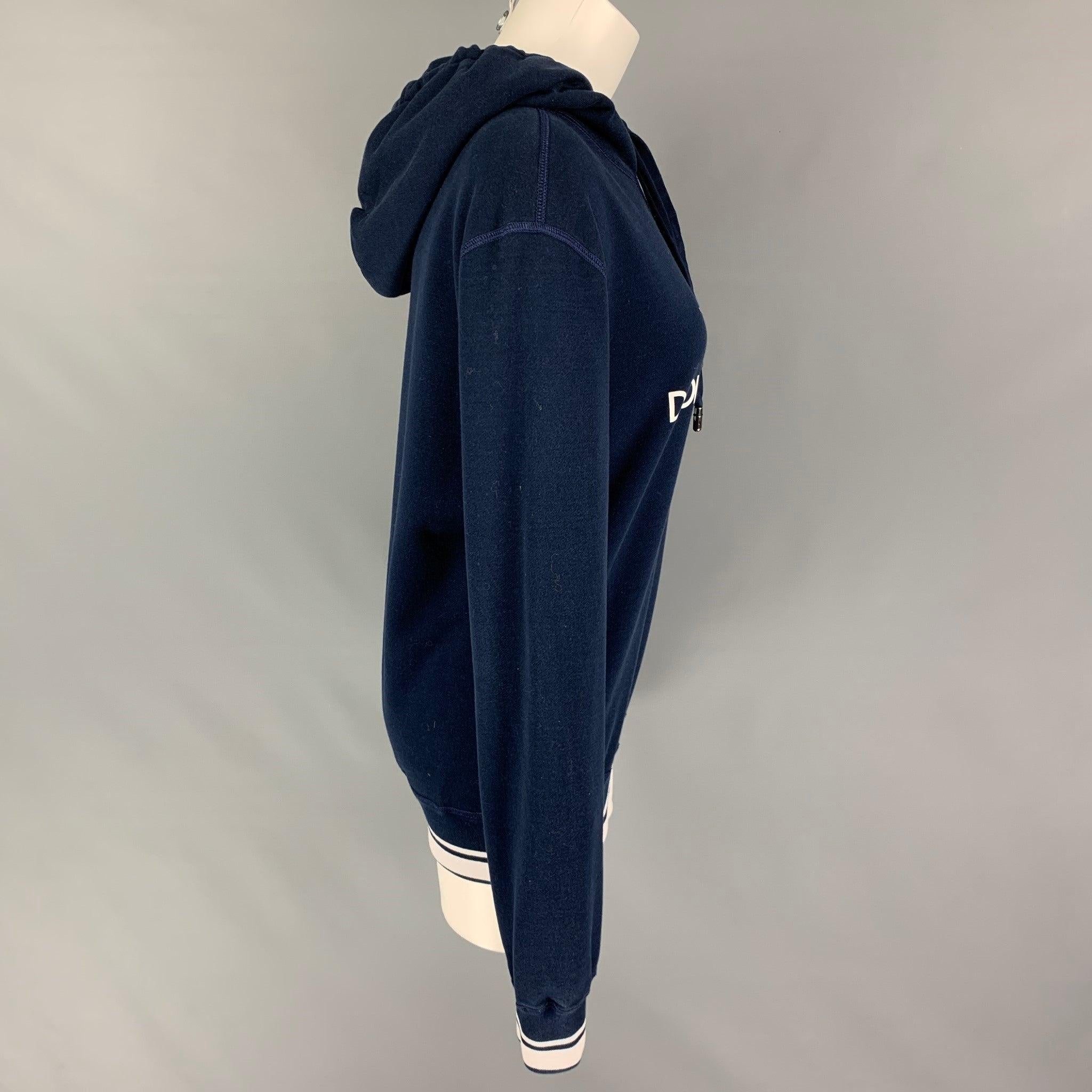 DOLCE & GABBANA sweatshirt comes in a navy & white cotton featuring a front logo design, hooded, ribbed hem, and a drawstring. Made in Italy.
Very Good
Pre-Owned Condition. 

Marked:   44 

Measurements: 
 
Shoulder: 18.5 inches  Bust: 39 inches 