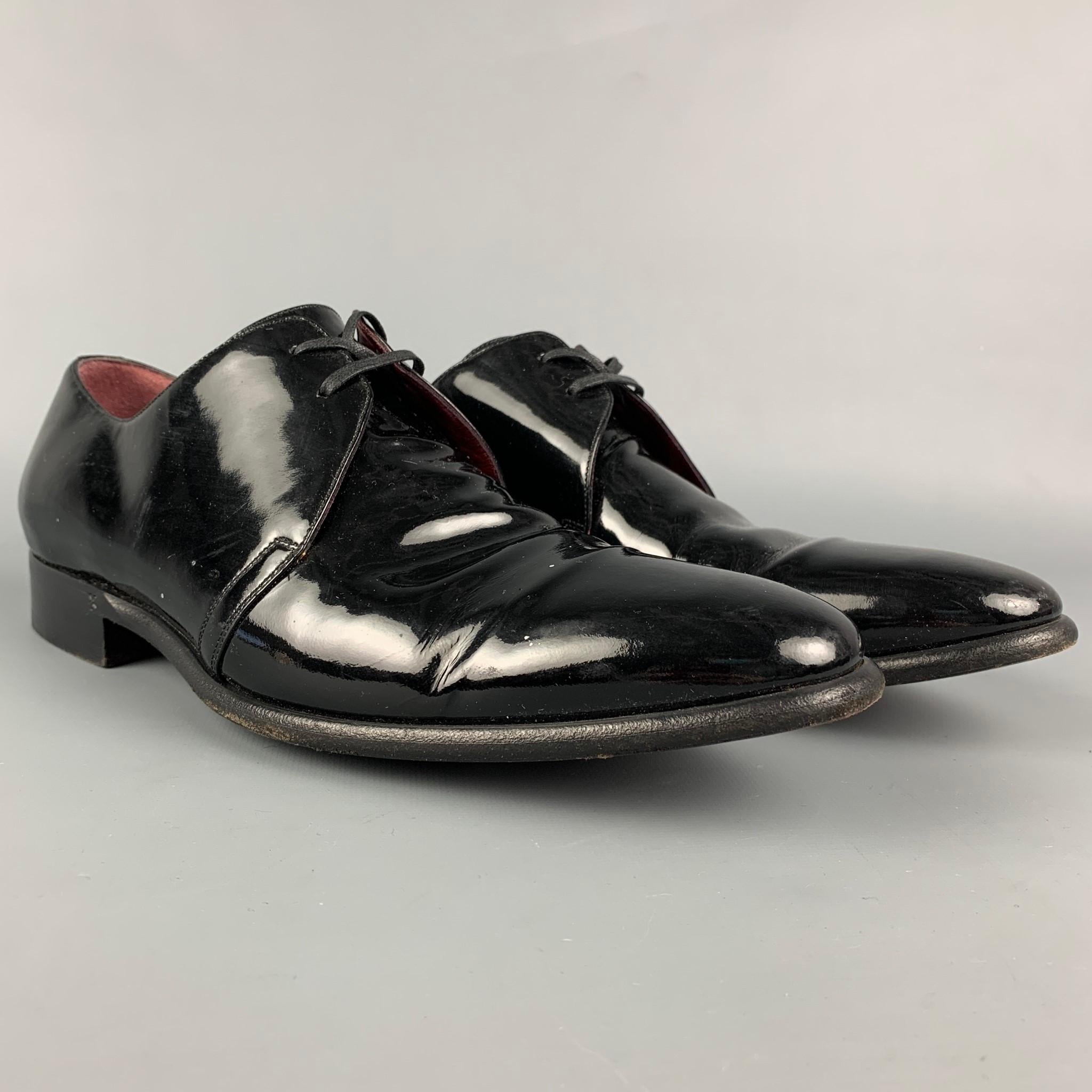 DOLCE & GABBANA shoes comes in a black patent leather featuring a cap toe and a lace up closure. Made in Italy. 

Very Good Pre-Owned Condition.
Marked: CA5249 7.5

Outsole: 12 in. x 4 in. 