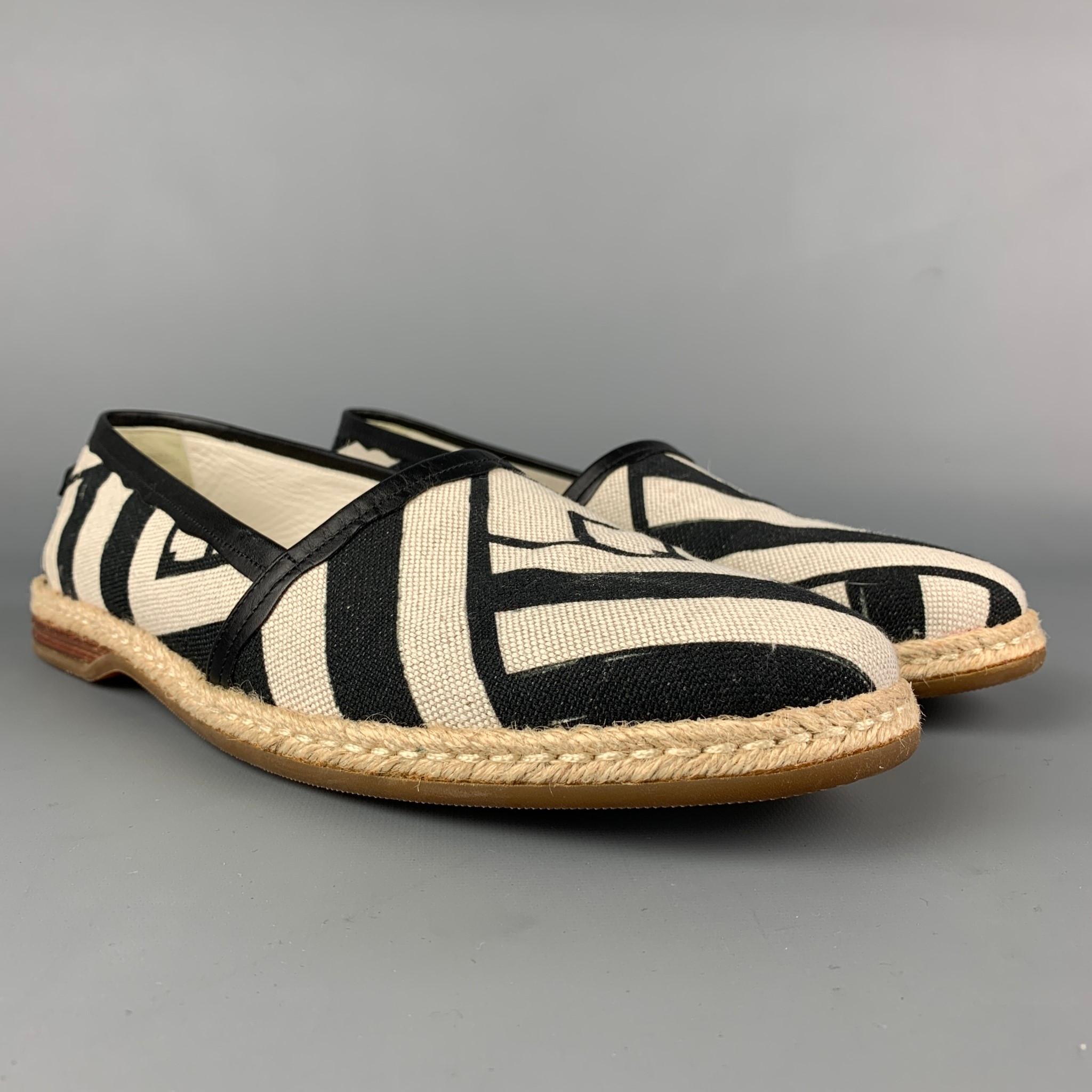 DOLCE & GABBANA loafers comes in a off white & black stripe canvas featuring a slip on style, rope trim, and a rubber sole. Made in Italy. 

Very Good Pre-Owned Condition.
Marked: A50039 8
Original Retail Price: $405.00

Outsole: 11.75 in. x 4 in. 