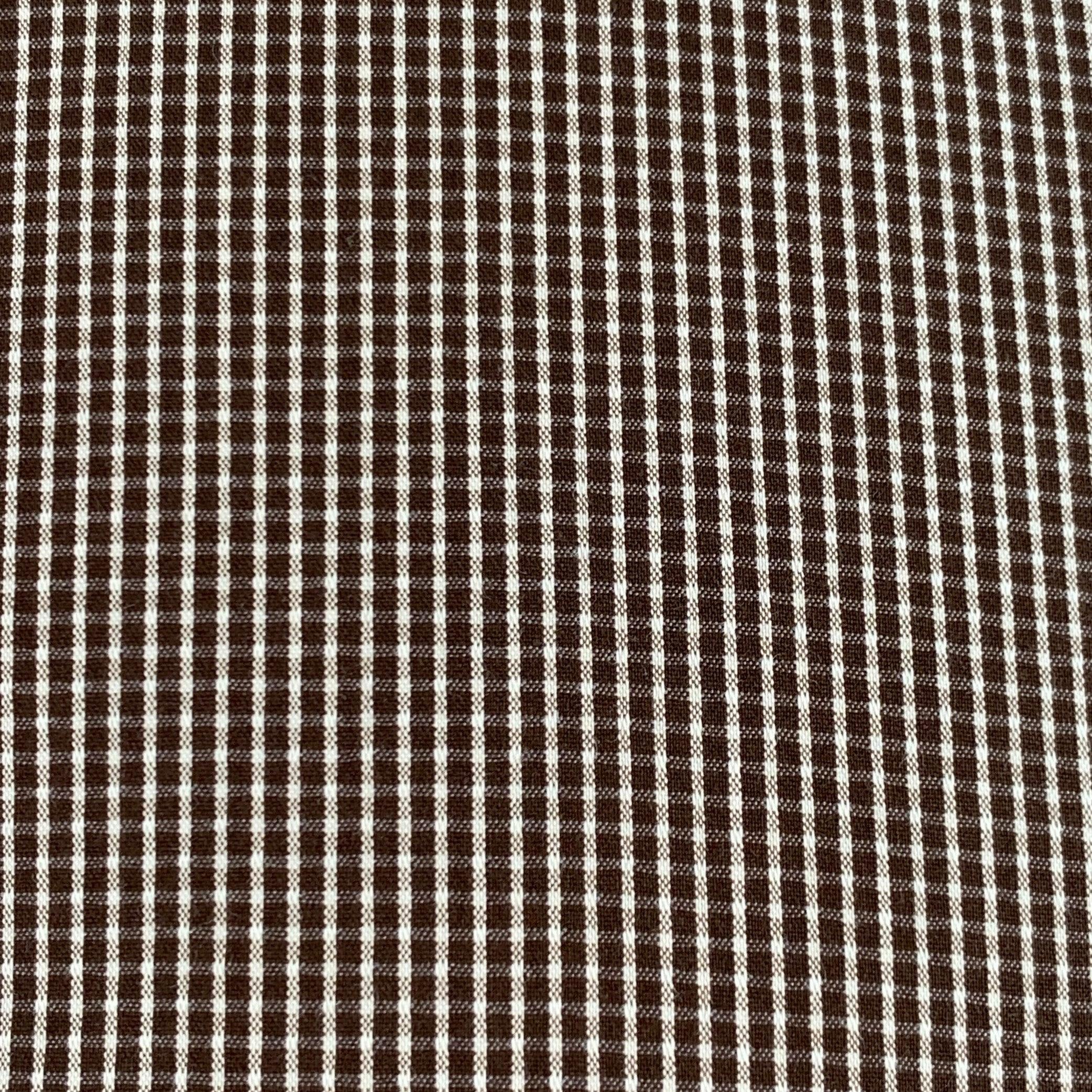 Camicia a maniche lunghe DOLCE & GABBANA SICILIA
in tessuto misto cotone marrone e bianco con motivo gingham, colletto aperto e chiusura con bottoni. Made in Italy. Eccellente condizione di usato.  

Contrassegnato:   16.5/42 

Misure: 
 
Spalla: 17