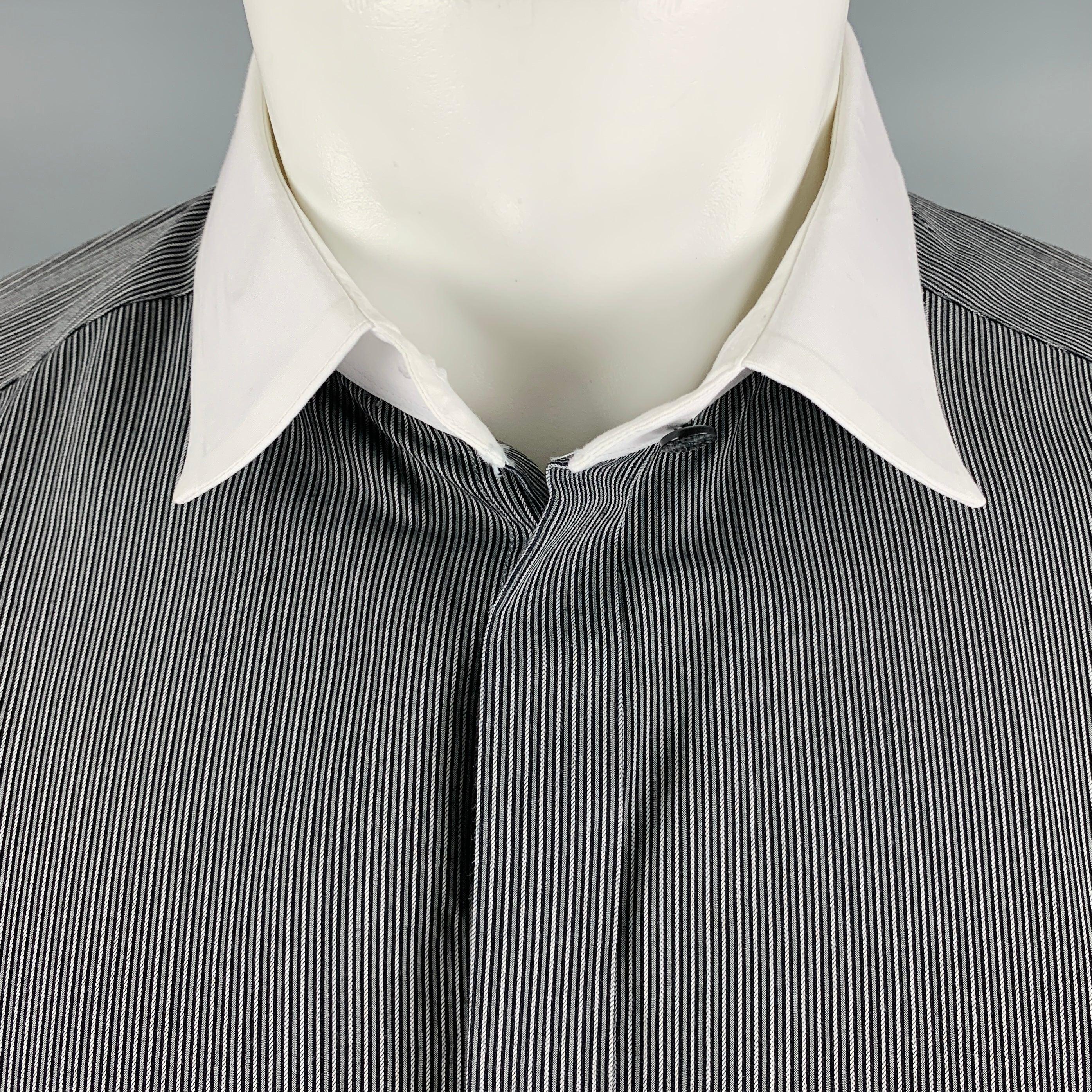 DOLCE & GABBANA long sleeve shirt in a black and white cotton fabric featuring pinstripe pattern, contrast white collar, and hidden button closure. Made in Italy.Excellent Pre-Owned Condition. 

Marked:   16.5/42 

Measurements: 
 
Shoulder: 17