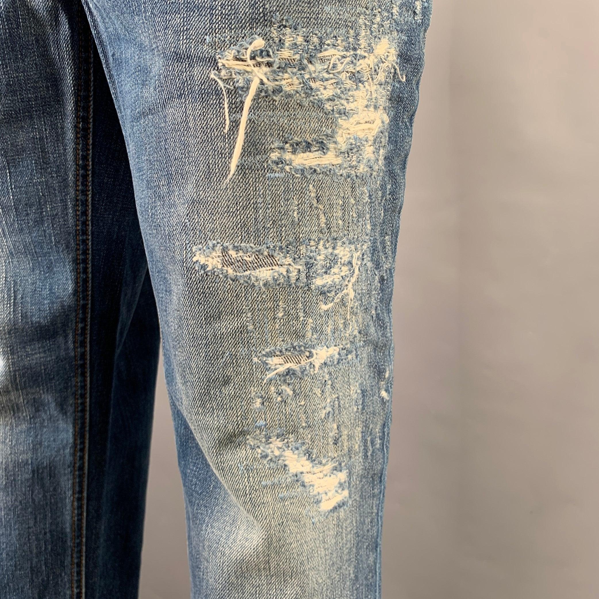 DOLCE & GABBANA jeans
in a blue cotton woven fabric featuring a distressed style, five pockets, and zip fly closure. Made in Italy.Excellent Pre-Owned Condition. 

Marked:   IT 44 

Measurements: 
  Waist: 34 inches Rise: 7 inches Inseam: 25 inches