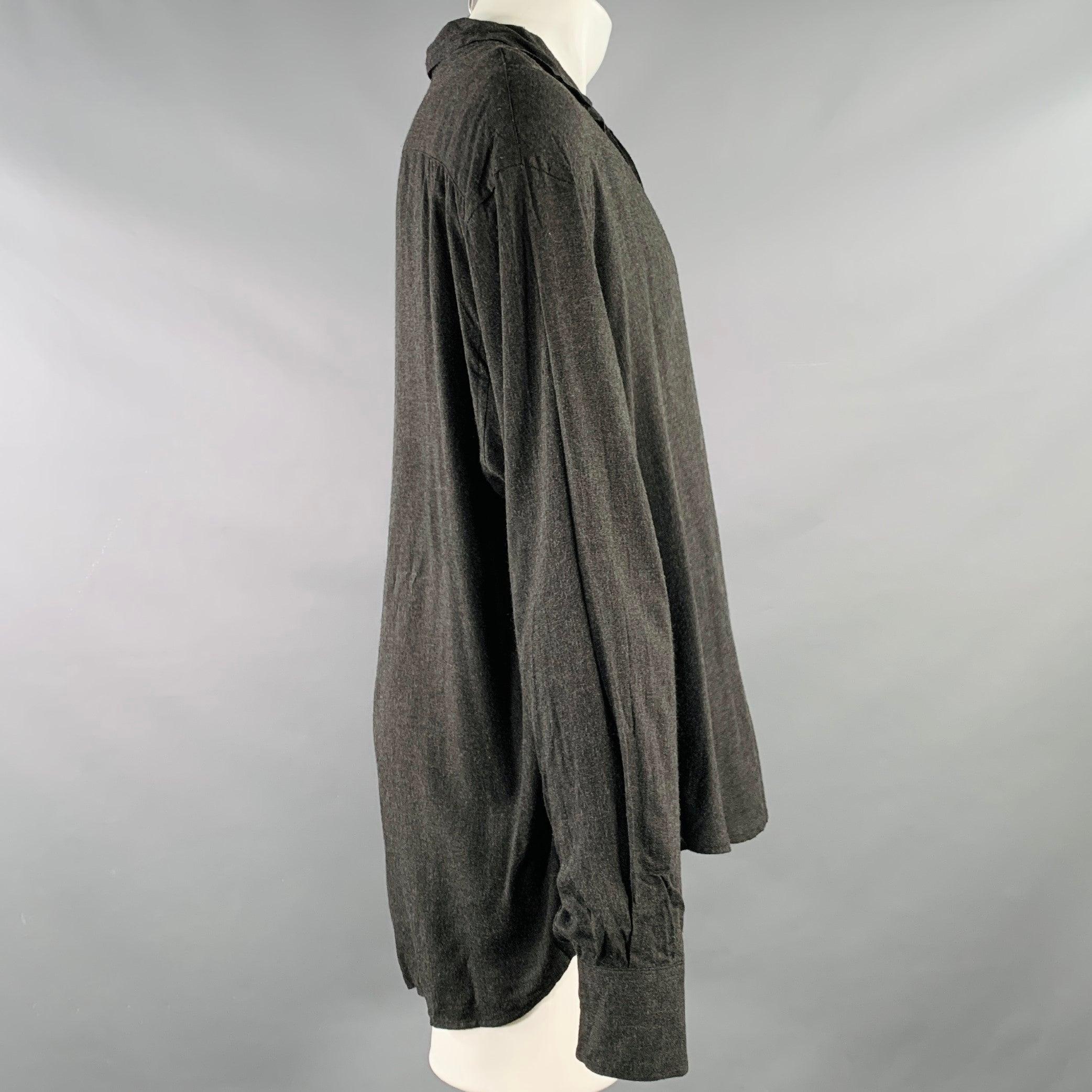DOLCE & GABBANA long sleeve shirt
in a charcoal grey viscose fabric featuring an oversized fit, one pocket, and button closure. Made in Italy.Excellent Pre-Owned Condition. 

Marked:   M 

Measurements: 
 
Shoulder: 22 inches  Chest: 53 inches 