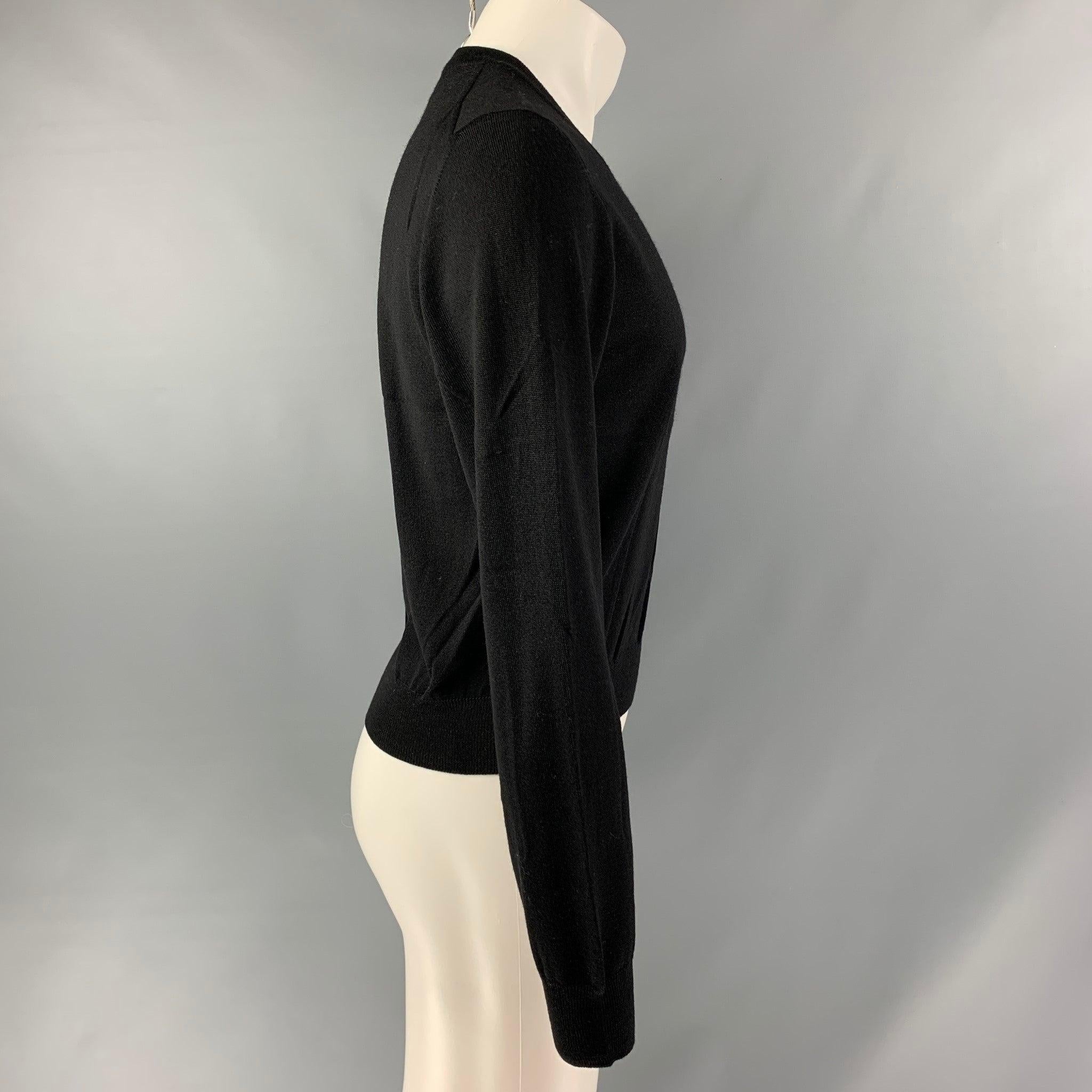 DOLCE & GABBANA pullover comes in a black wool jersey knit featuring a v-neck. Made in Italy. Very Good Pre-Owned Condition. 

Marked:   48 

Measurements: 
 
Shoulder: 17.5 inches Chest: 46 inches Sleeve: 26 inches Length: 22.5 inches  
  
  
