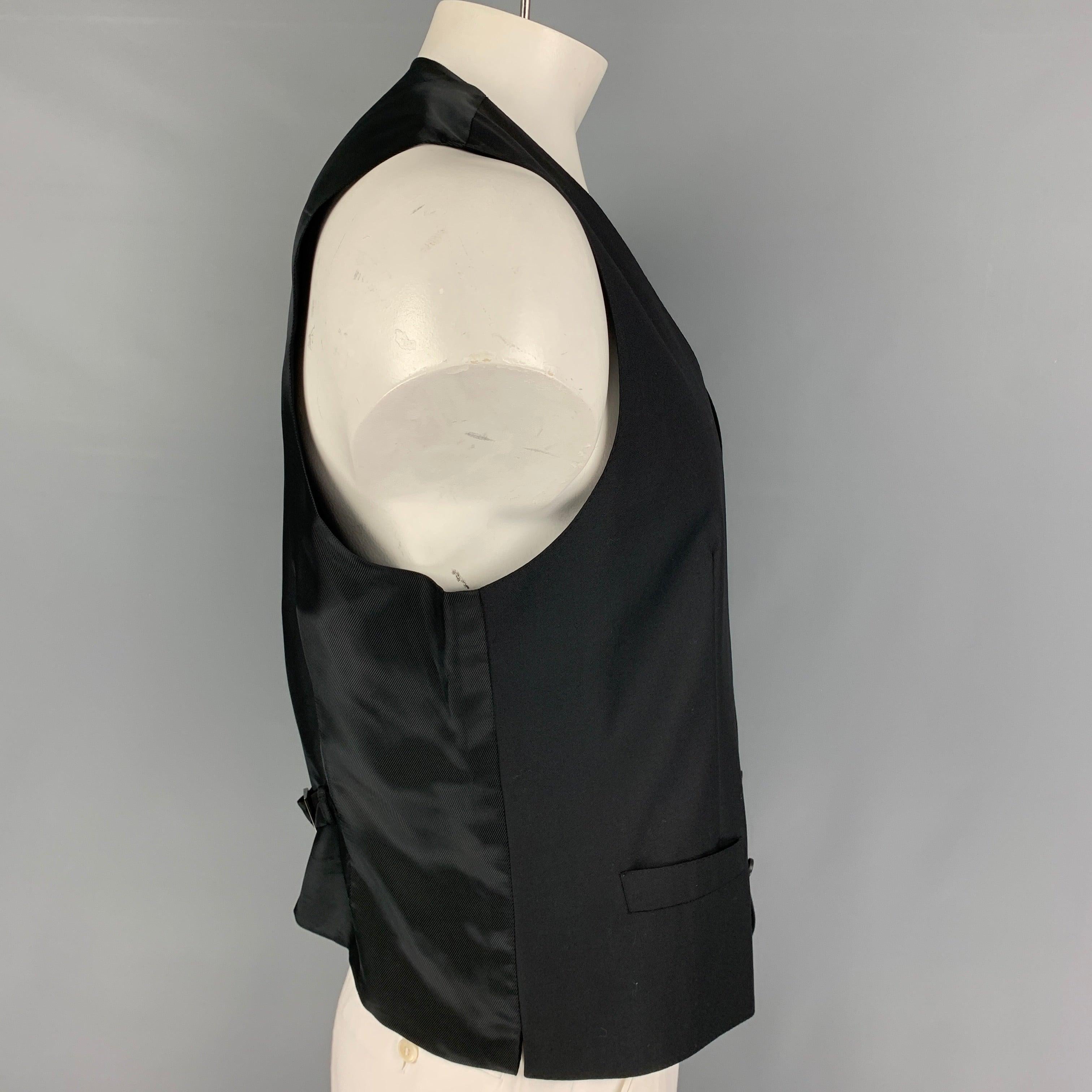 DOLCE & GABBANA vest comes in a black viscose blend featuring a adjustable back strap, slit pockets, and a buttoned closure. Made in Italy.
Excellent
Pre-Owned Condition. 

Marked:   54 

Measurements: 
 
Shoulder: 15 inches  Chest:
44 inches