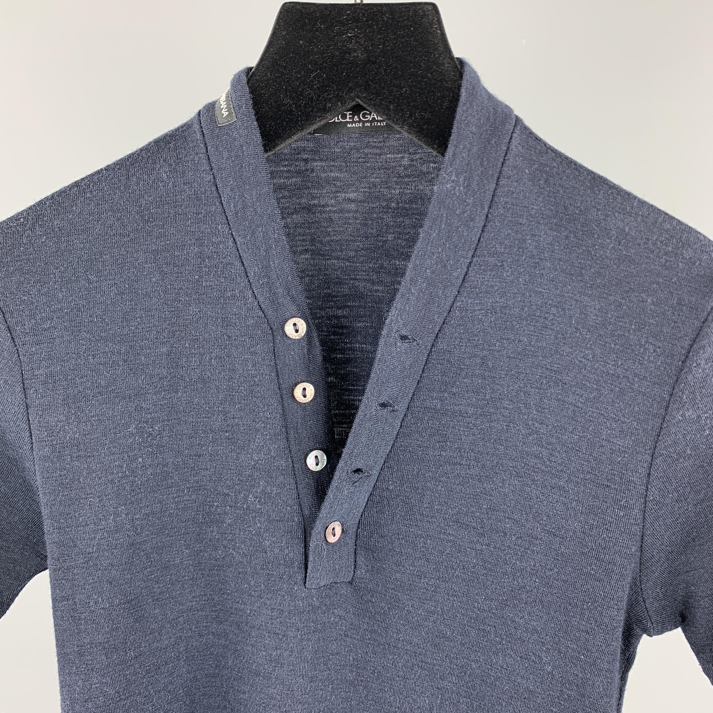 DOLCE & GABBANA henley pullover sweater comes in a solid navy wool / silk material, featuring four buttons at V-neck, short sleeves and a brand tag at shoulder. Made in Italy.

Excellent Pre-Owned Condition.
Marked: IT 46

Measurements:

Shoulder: