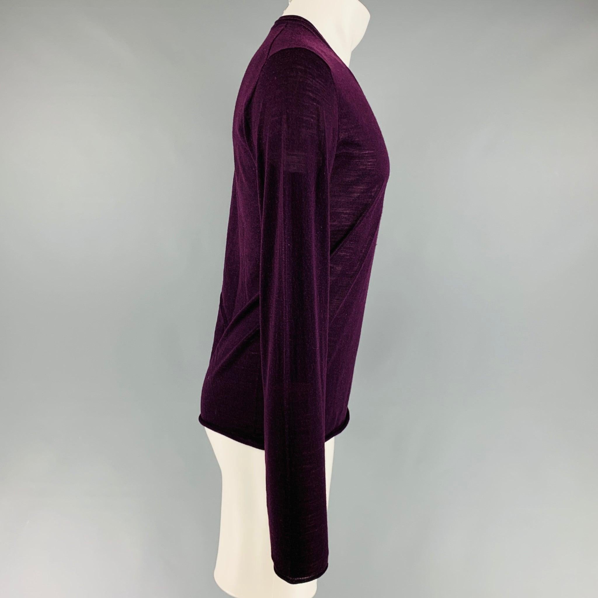 DOLCE & GABBANA pullover comes in a purple wool knit featuring a v-neck. Made in Italy. Excellent Pre-Owned Condition. 

Marked:   46 

Measurements: 
 
Shoulder: 17 inches Chest: 42 inches Sleeve: 27.5 inches Length: 26 inches  
  
  
 
Reference