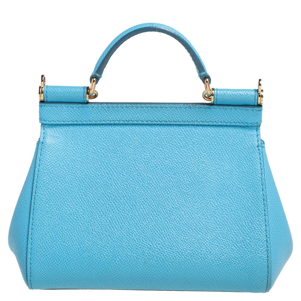 The iconic Miss Sicily bag by Dolce & Gabbana is named after Domenico Dolce's native land and exhibits the aesthetic of Italian glamour. The neat silhouette is made from leather in a sky blue shade and features a front flap accented with the