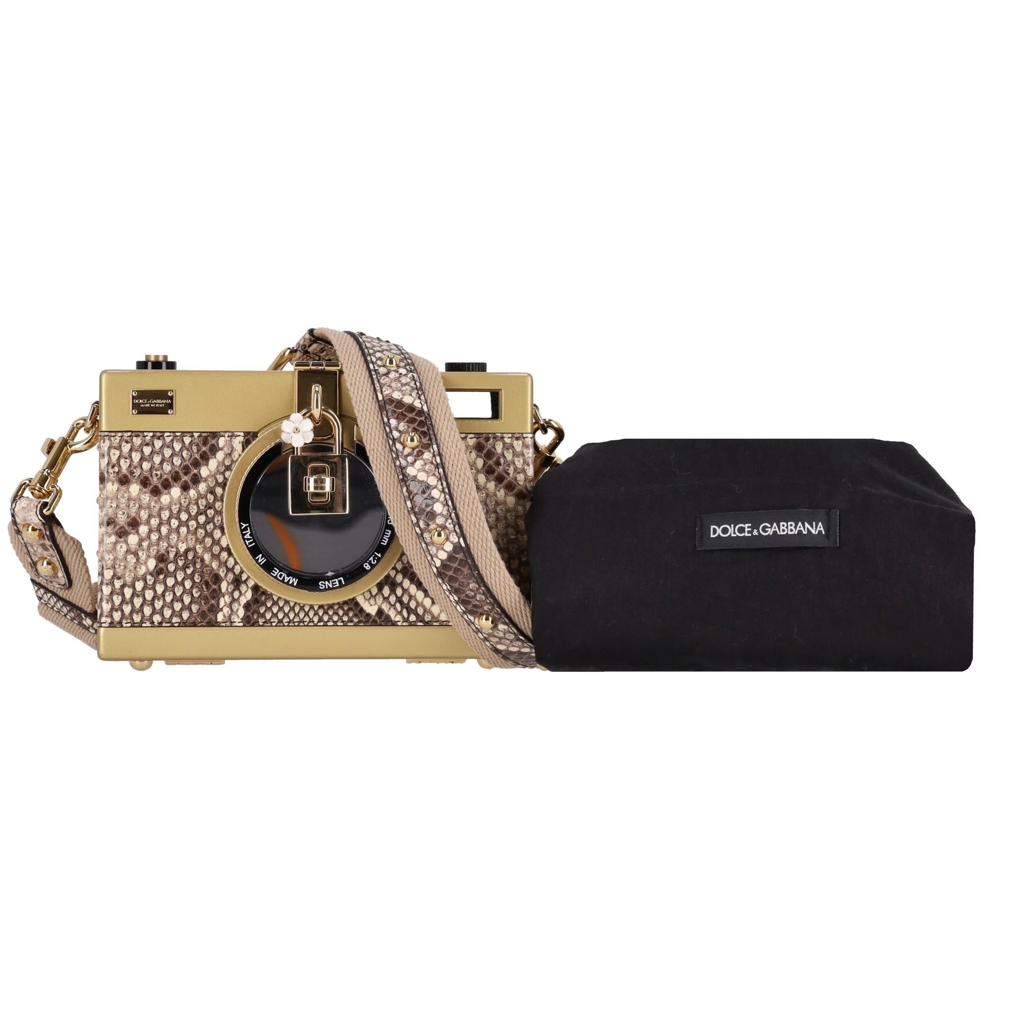 Dolce & Gabbana Snakeskin Camera Bag

Brown hardcase crossbody bag crafted from snakeskin leather with gold hardware.

Detailed with decorative padlock with white enamel flower.

Featuring a turn lock closure, lens and removable, canvas, studded