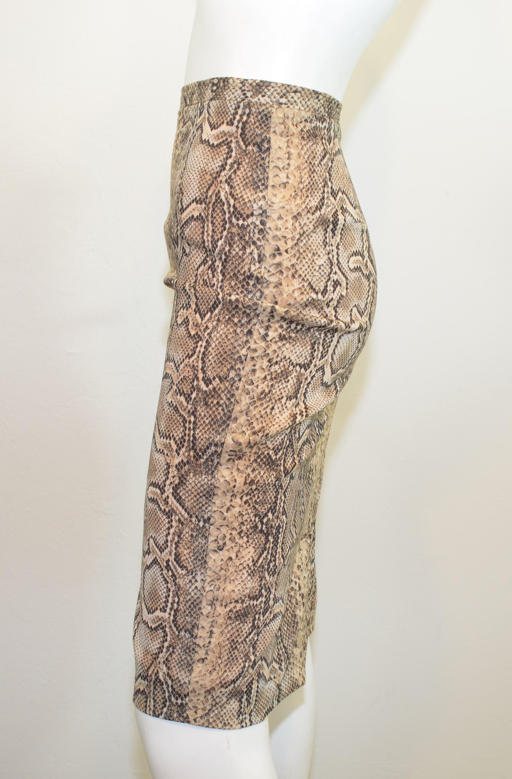 Dolce & Gabbana Snakeskin Pencil Skirt -- featured in a neutral beige and black, back zipper fastening, full lining, and composed with a silk, nylon, and lycra blend. Skirt is a size 46, made in Italy.

measurements:
waist 32''
hips 38''
length 24''