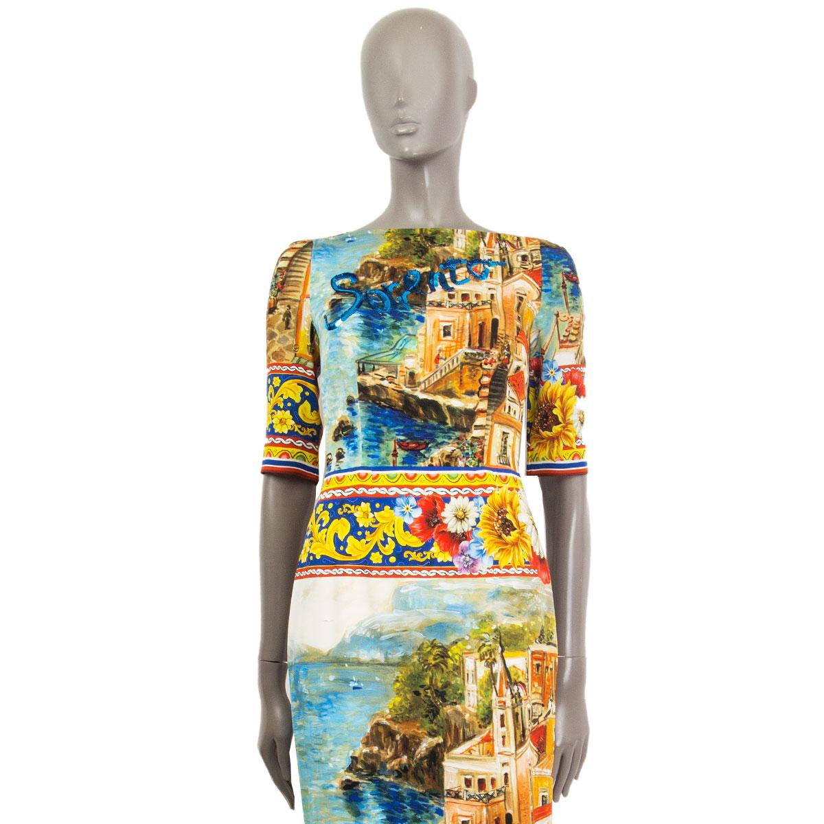 100% authentic Dolce & Gabbana 3/4 sleeve sheath dress in multicolor Sorrento print silk charmeuse (94%) and elastane (6%) featuring a wide neckline that runs horizontally. Lined in white silk (96%) and elastane (4%). Blue sequins embellishment at