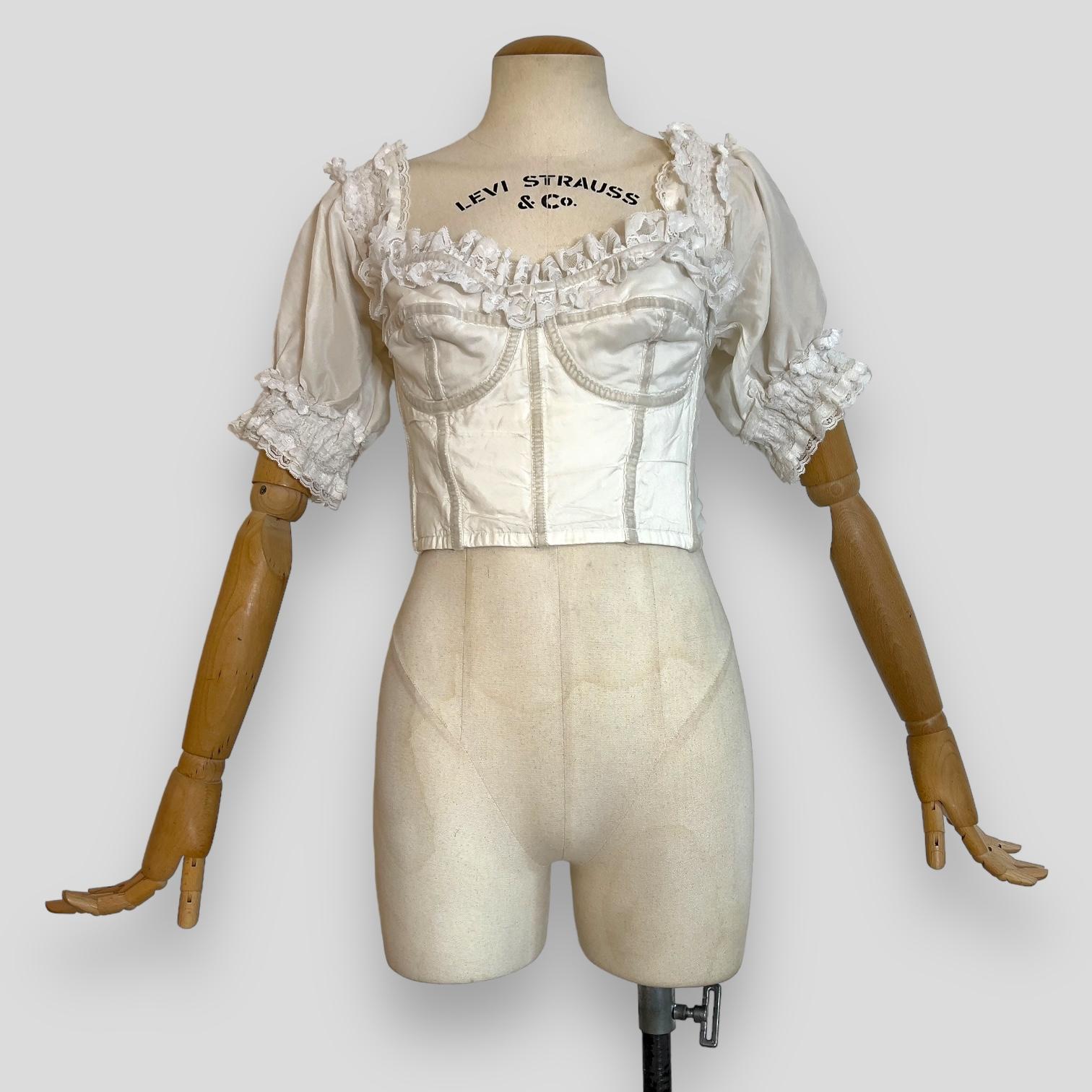 Dolce & Gabbana Spring Summer 1993 Collection

Introducing a stunning piece from Dolce & Gabbana's Spring Summer 1993 collection by Domenico Dolce and Stefano Gabbana. This vintage corset, tagged as size M-L (44IT).  It features a delicate lace