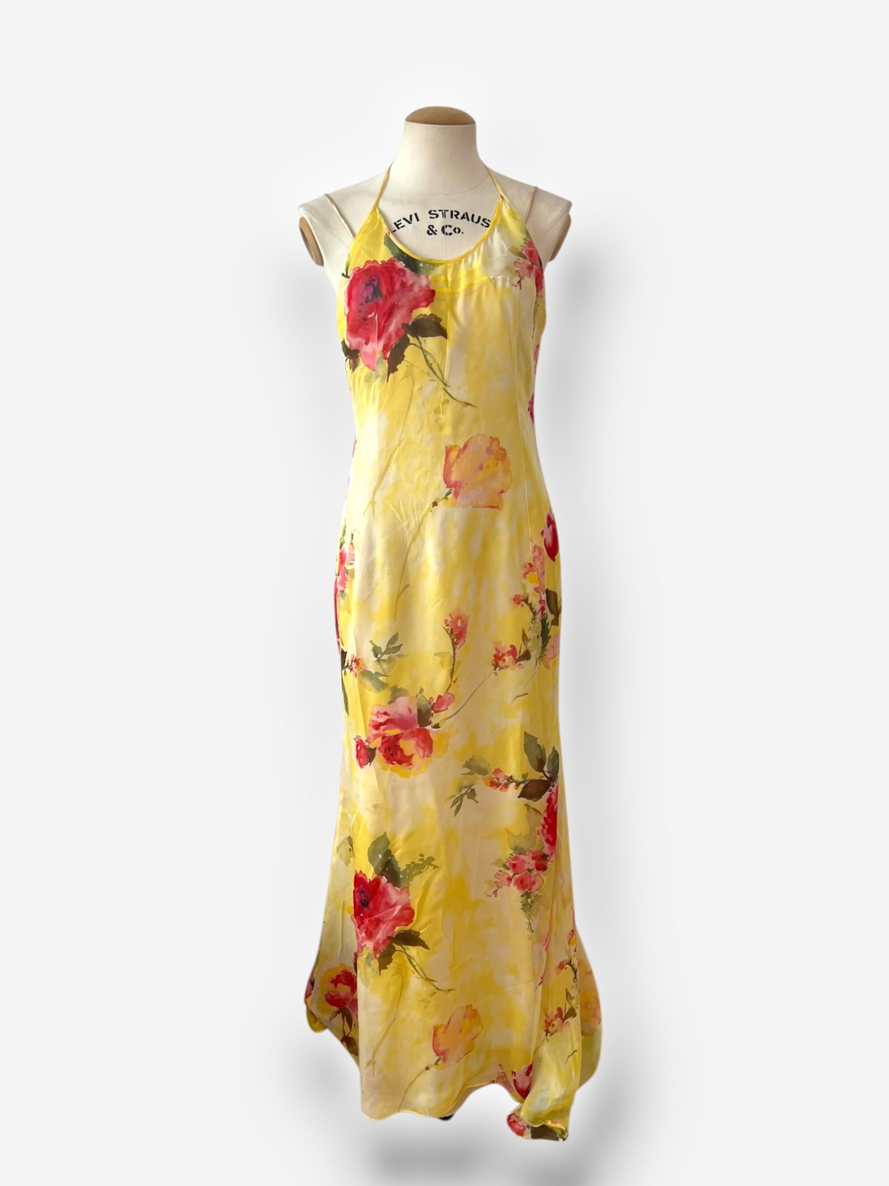 

A luminous archival piece from Dolce & Gabbana’s Spring/Summer 1997 collection, this gown is crafted from delicate sheer silk in a rich, watercolor-style floral print. The layered design includes a lightweight underdress for coverage, while the