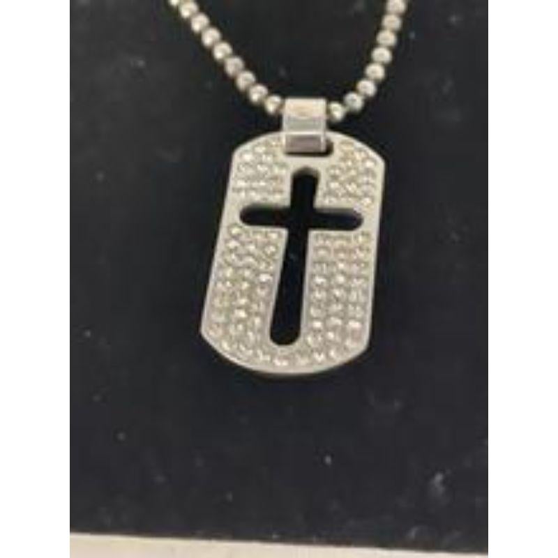 This dog tag style pendent necklace has a unique cut out cross design in the middle, surrounded by rhinestones.  Sterling silver pendant and chain. Marked 925 sterling on the pendent loop. Dolce & Gabbana brand stamp on the back. This is reversible.