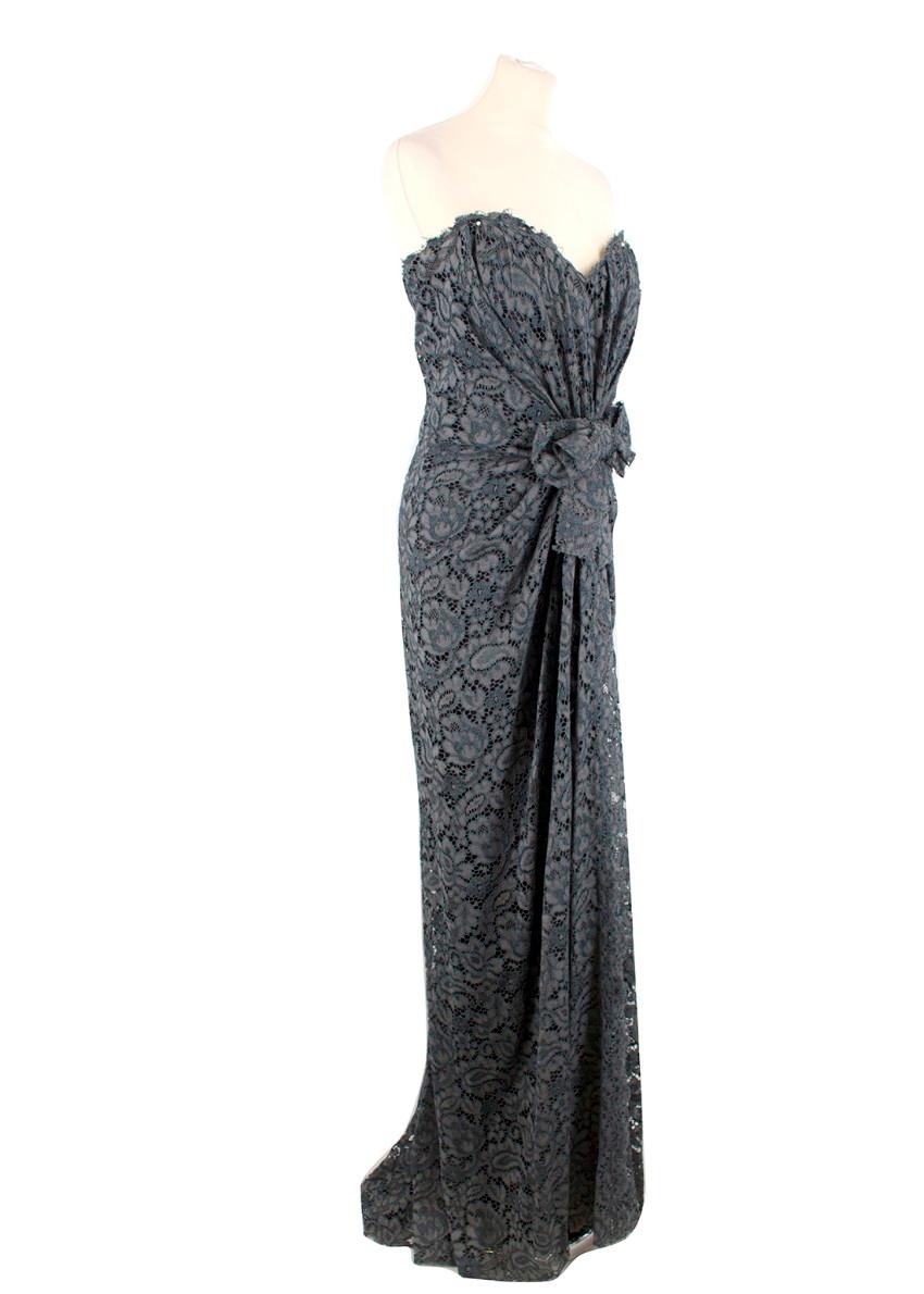 Dolce & Gabbana Grey Lace Ruched Gown

- Sleeveless
- Sweetheart neckline
- Boned at the bust
- Bow and ruching detail to the front
- Cut close to the body
- Concealed zipper to the back 
- Padded cups
- Black slip underneath with zip and pop button