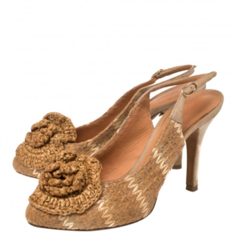Perfect for summer and beyond, Dolce & Gabbana's slingback pumps in raffia and leather are full of charm. They're detailed with a flower on the toes and are held by buckled slingback straps. Platforms and 10 cm heels ensure an elevated walk.