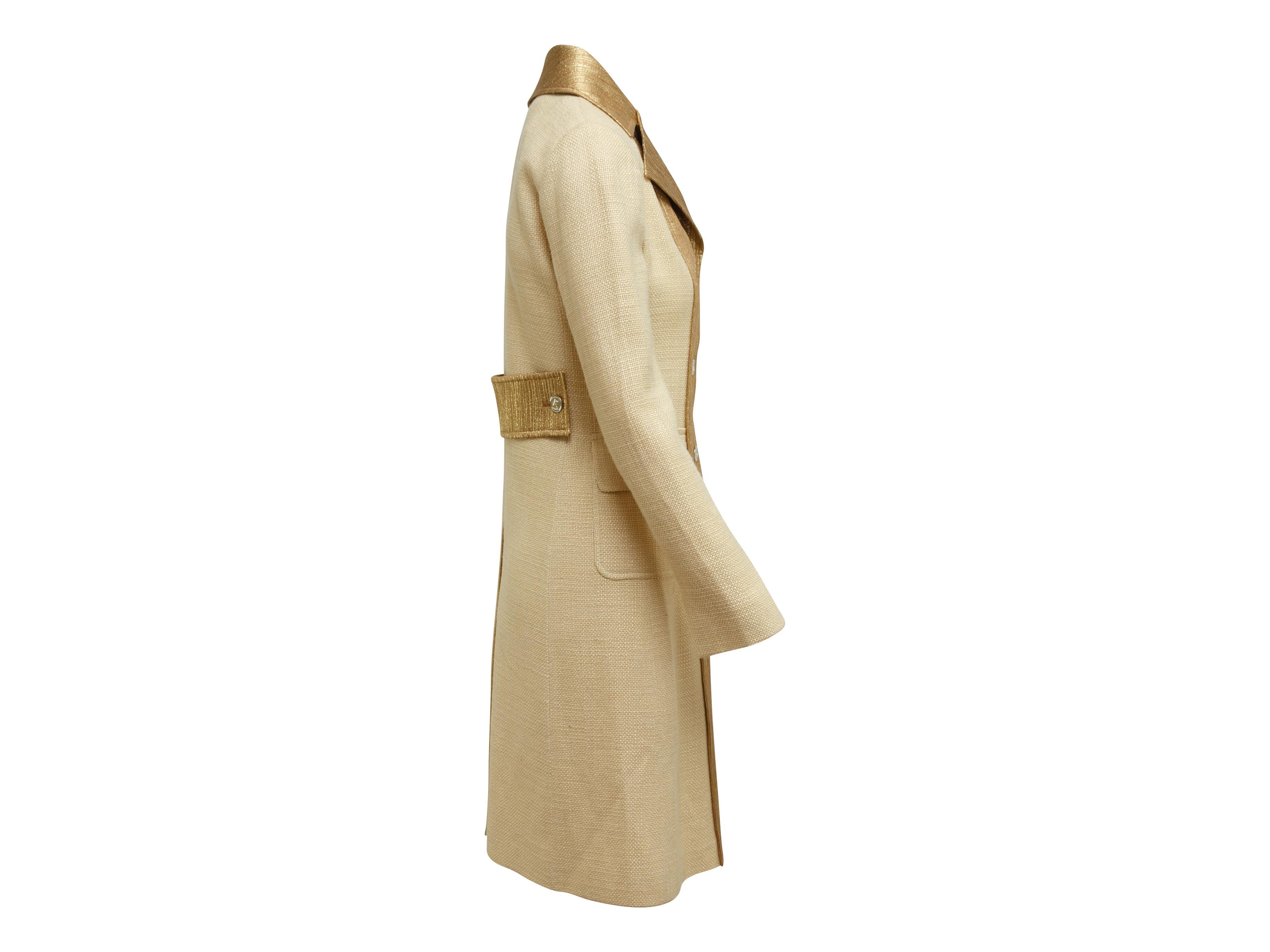 Product details: Tan and gold long coat by Dolce & Gabbana. Notch collar. Dual flap pockets at hips. Button closures at center front. Designer size 40. 35